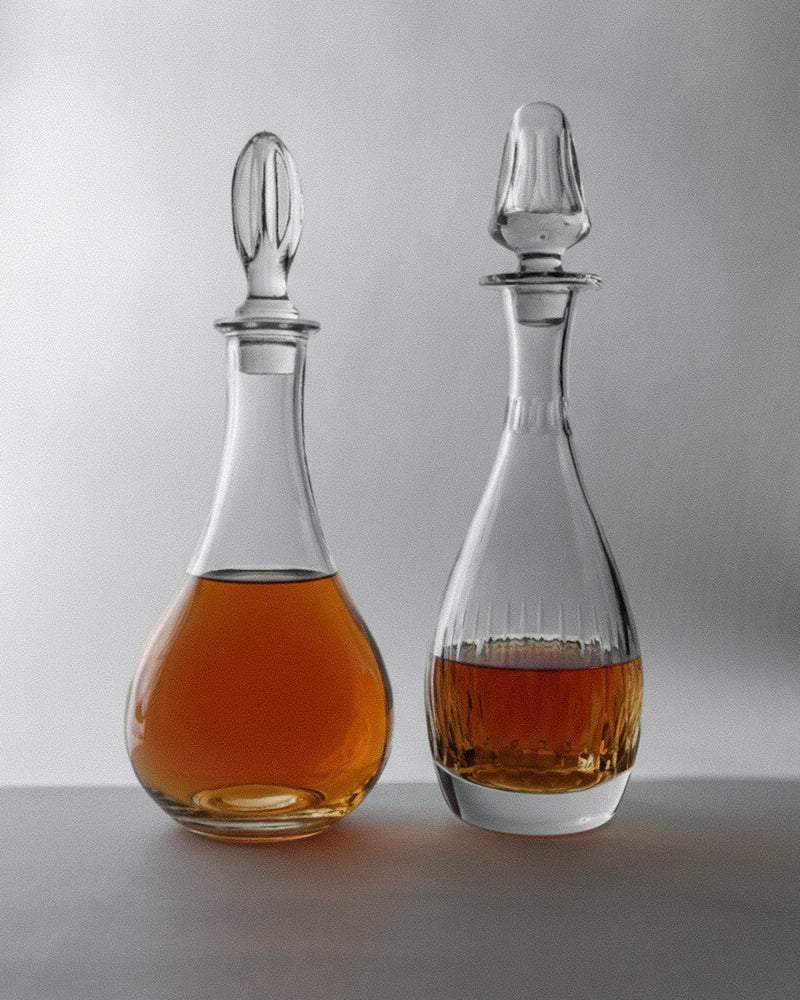 Vintage 1980s Glass Decanter Set of 2 — close-up of glass decanters with amber liquid