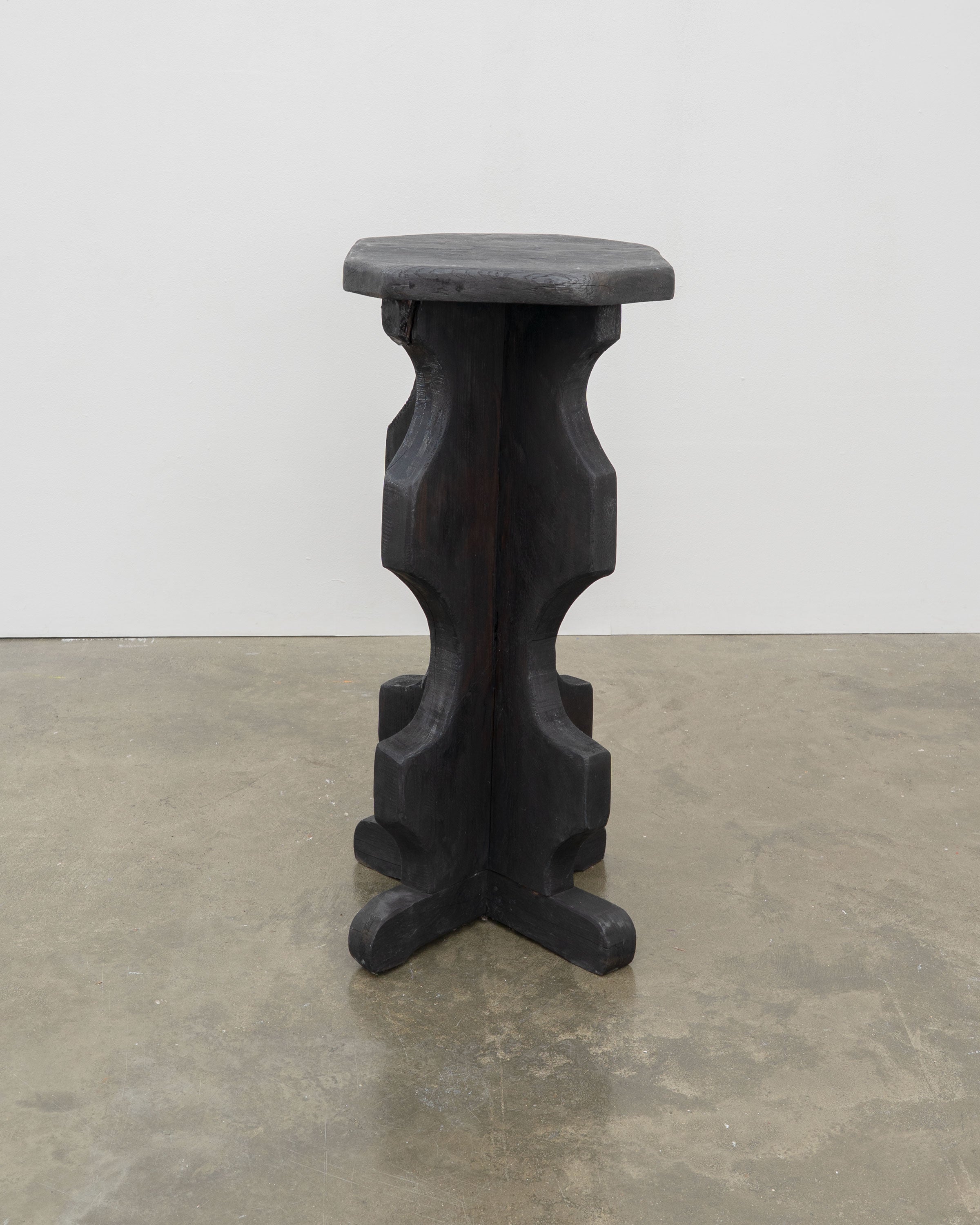 Sculptural Brutalist Bar Stools — side view of black wooden stool