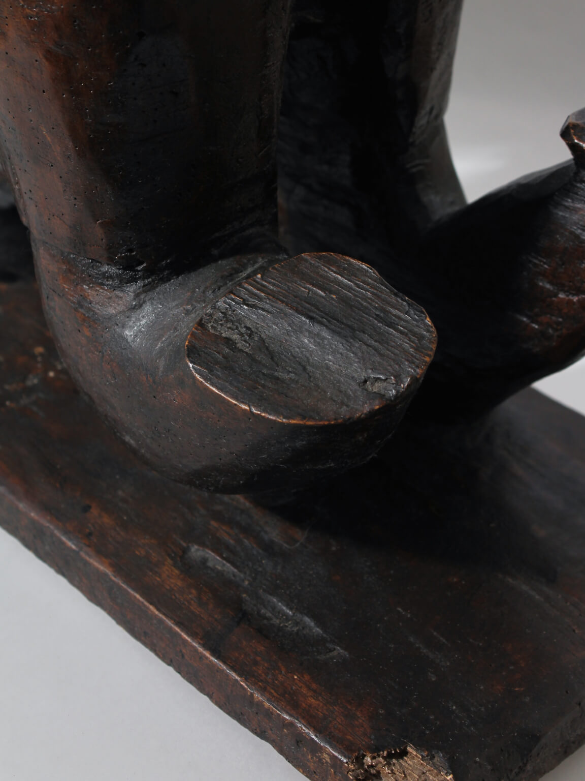 Large African Ashanti Figural Stool — close-up of dark wood base