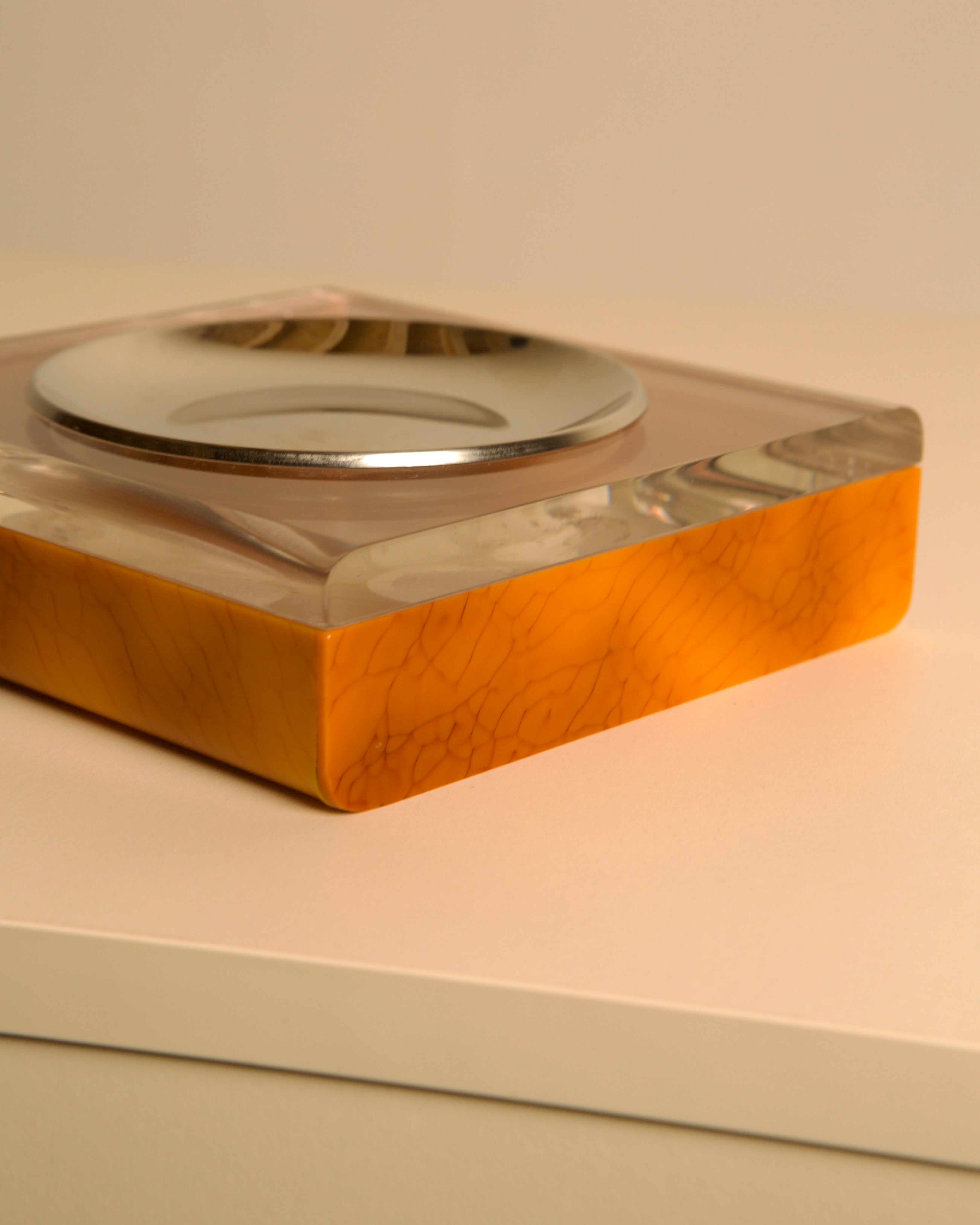 Italian 70s plexiglass and brown bakelite valet tray — side angle highlighting orange base color
