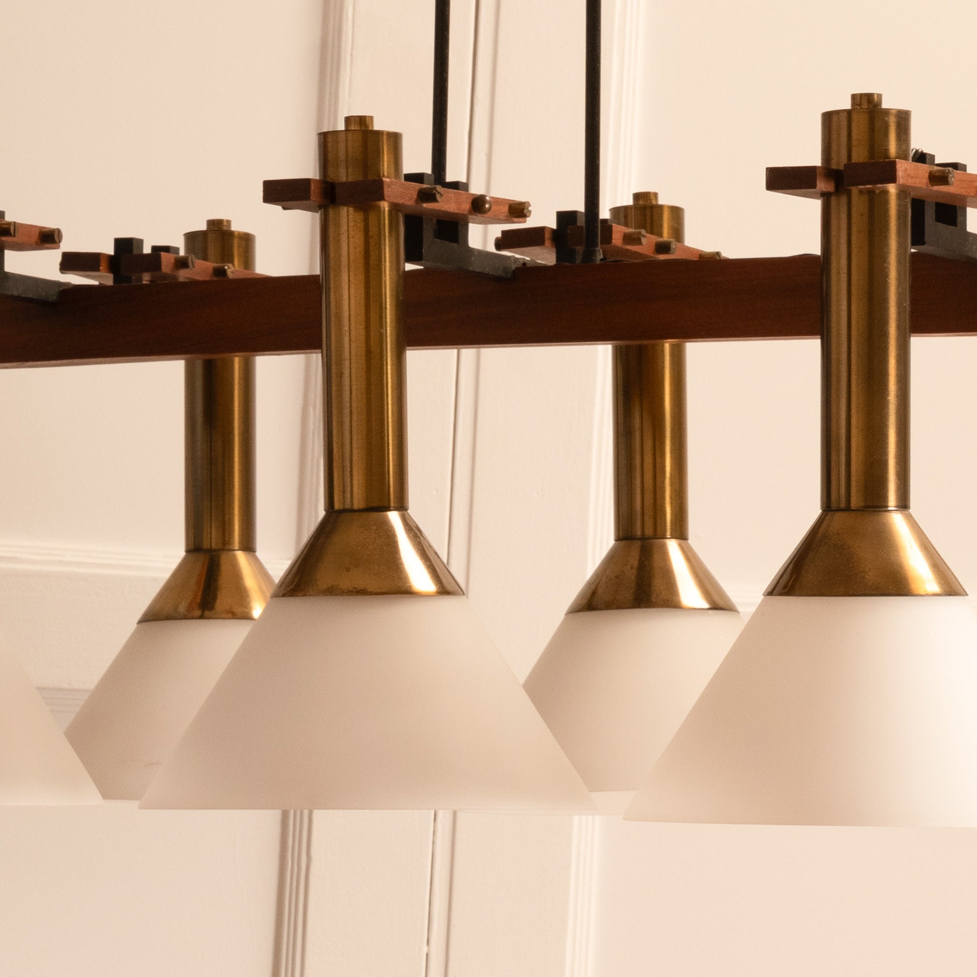 Six-light pendant lamp — close-up of frosted glass shades and brass details