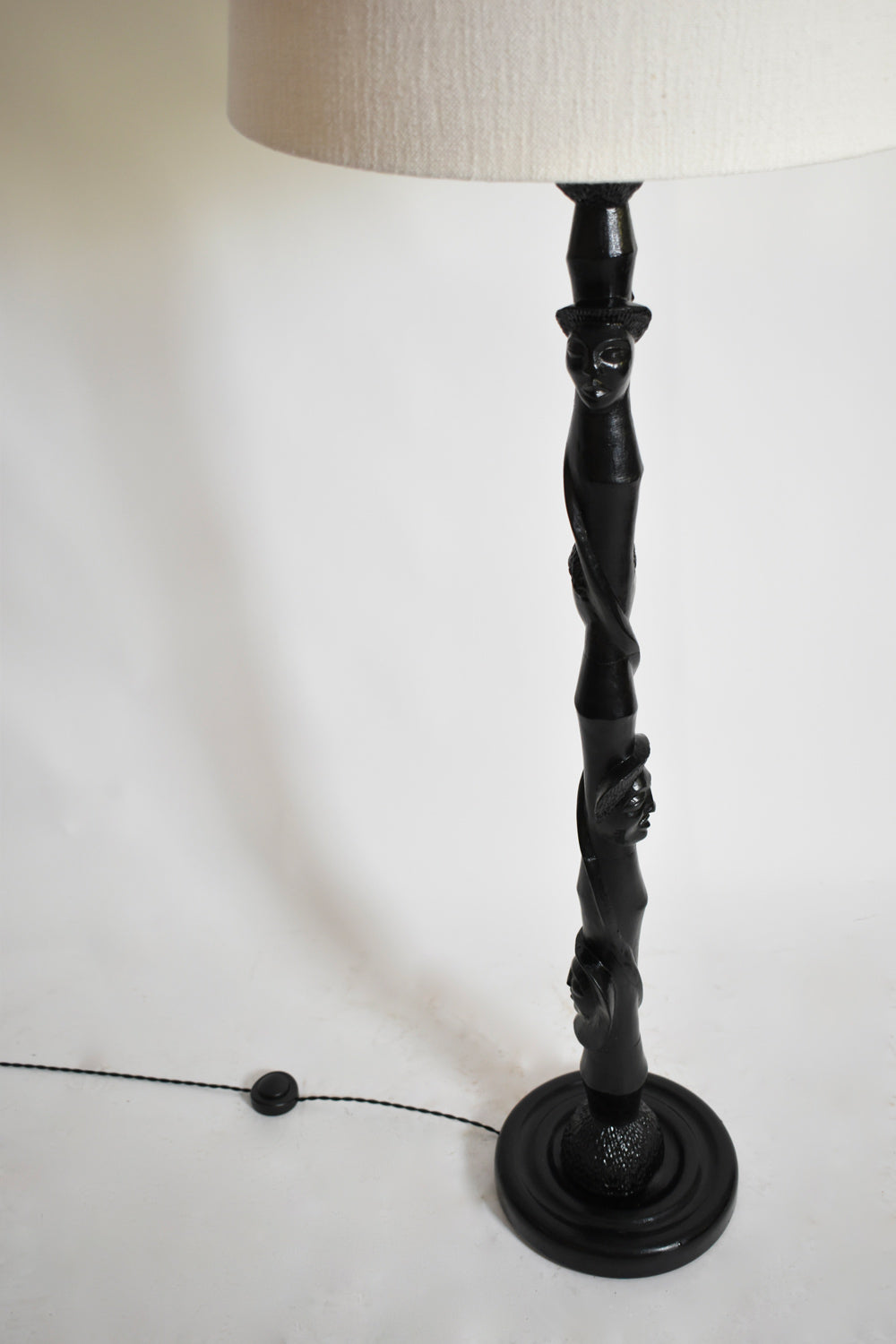 Africanist ebonised wood floor lamp, 1970s — lifestyle setting