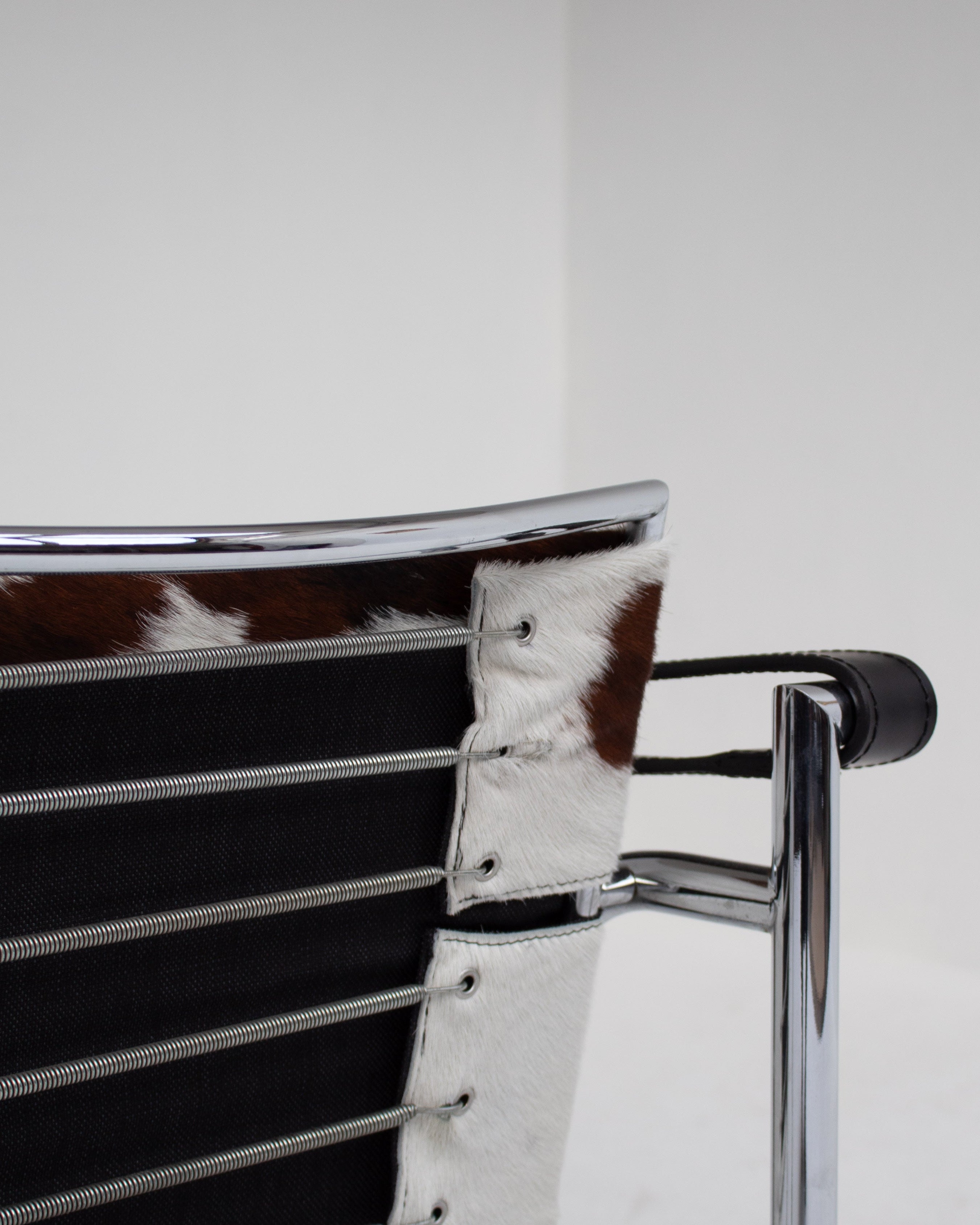 Detail view of LC1 chair cowhide upholstery and chrome frame