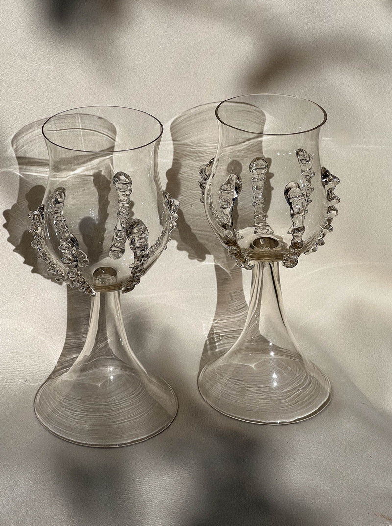 The Pair of Mouthblown Wine Goblets - Ribbed by Lucie Claudia Podrabska features elegant ribbed glass details, creating a refined medieval look—perfect for elevating any sophisticated setting.