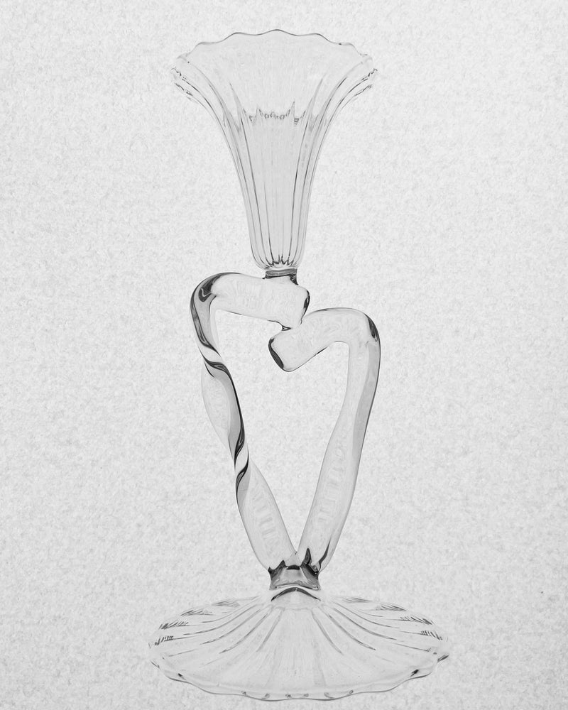 Clear glass ribbon-shaped candleholder with fluted top and base