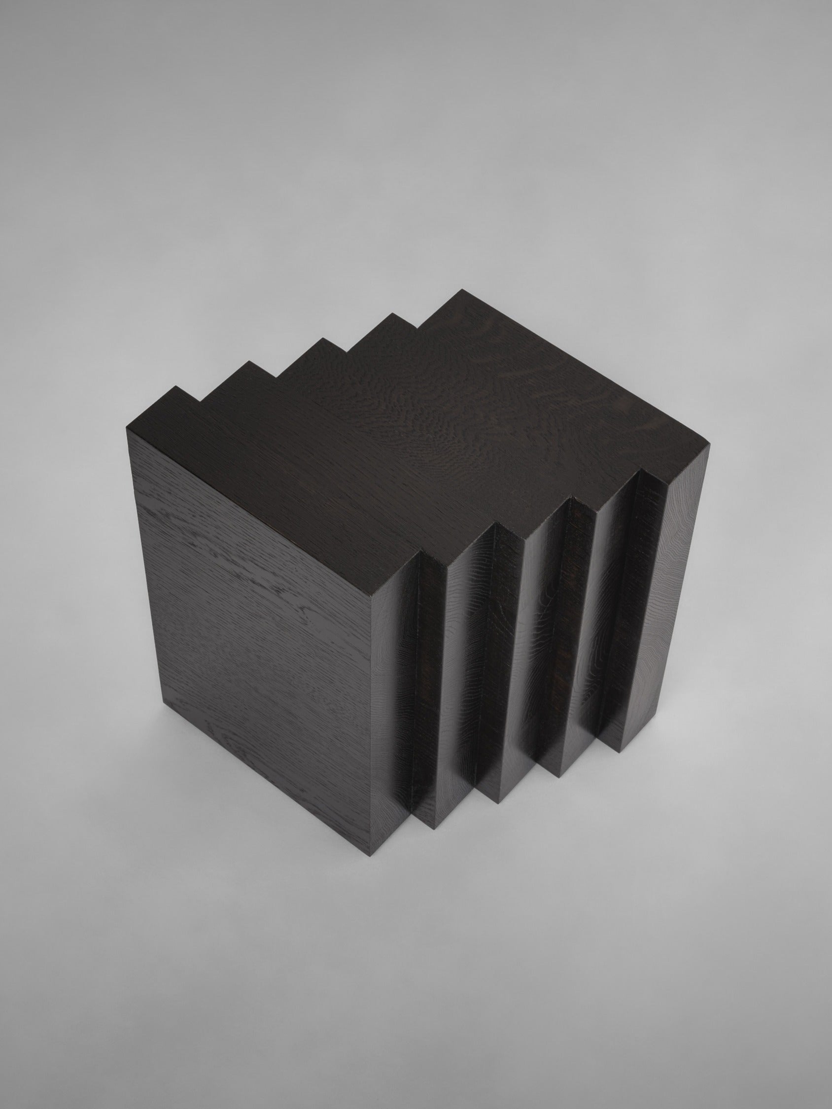 Scalae Side Table — top view of black wood with layered design