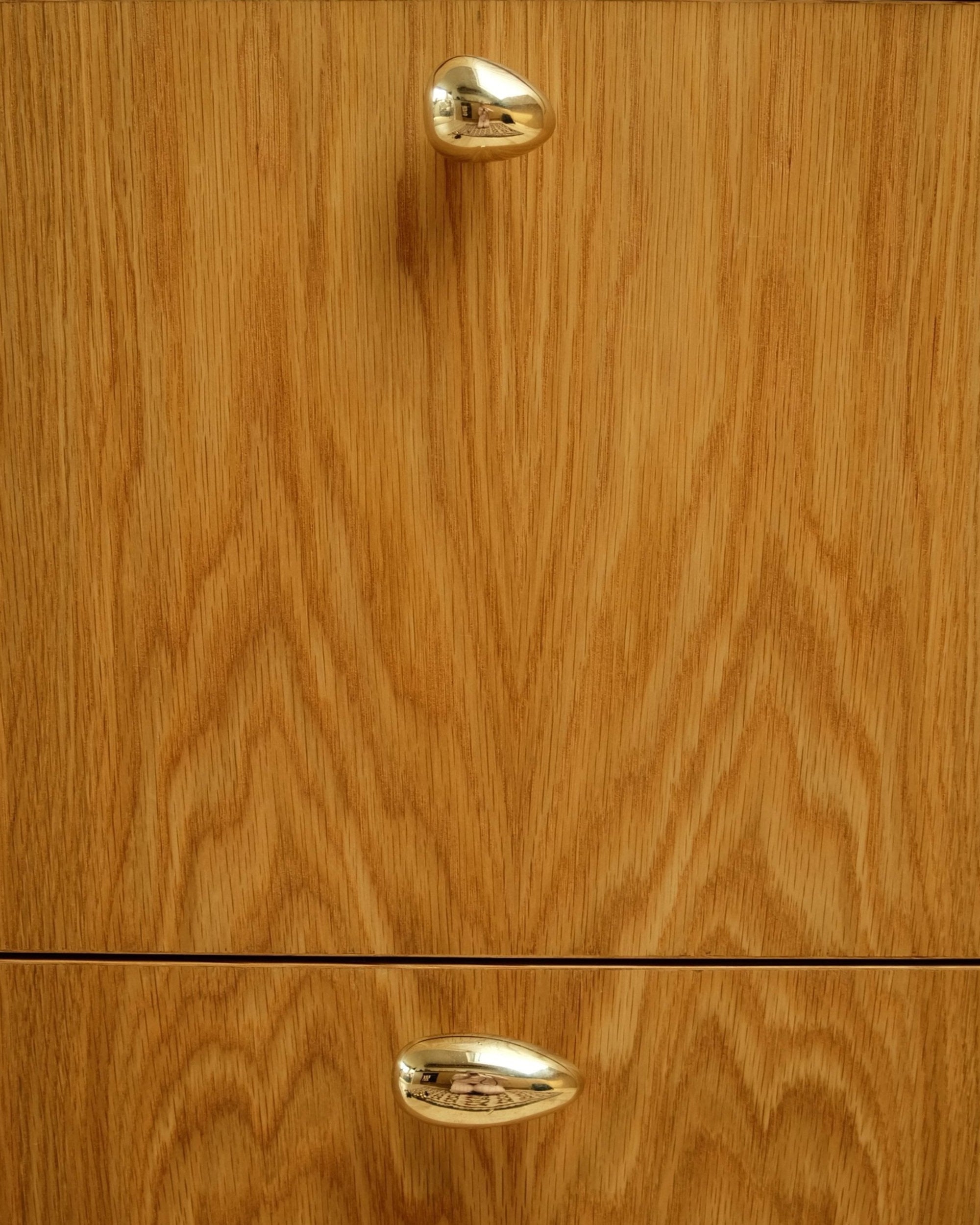 MOMI Cabinet Knob/Wall Hook Long Mini — close-up on wooden cabinet with brass knob