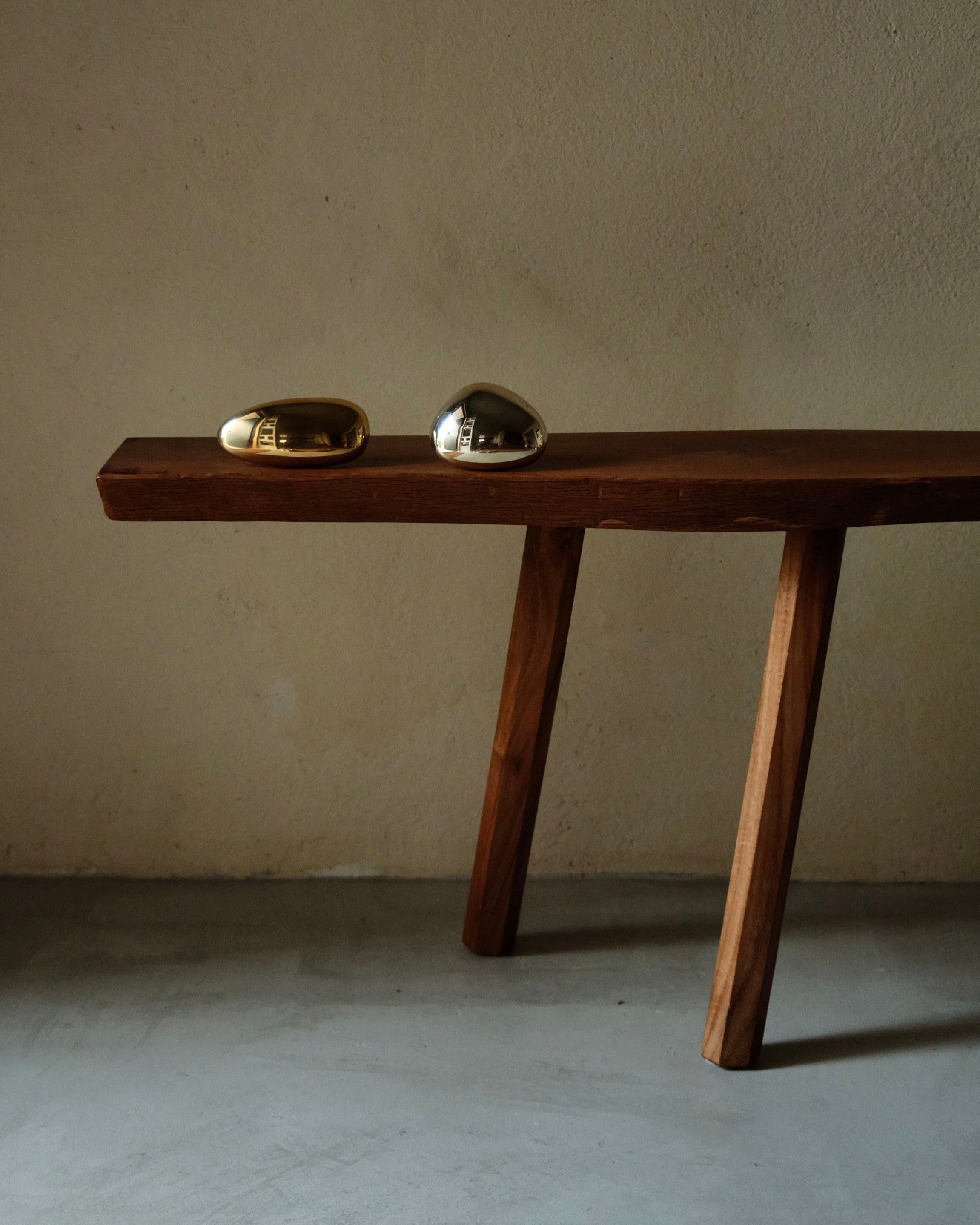 MOMI Cabinet Knob/Wall Hook Short — angled view on wooden bench