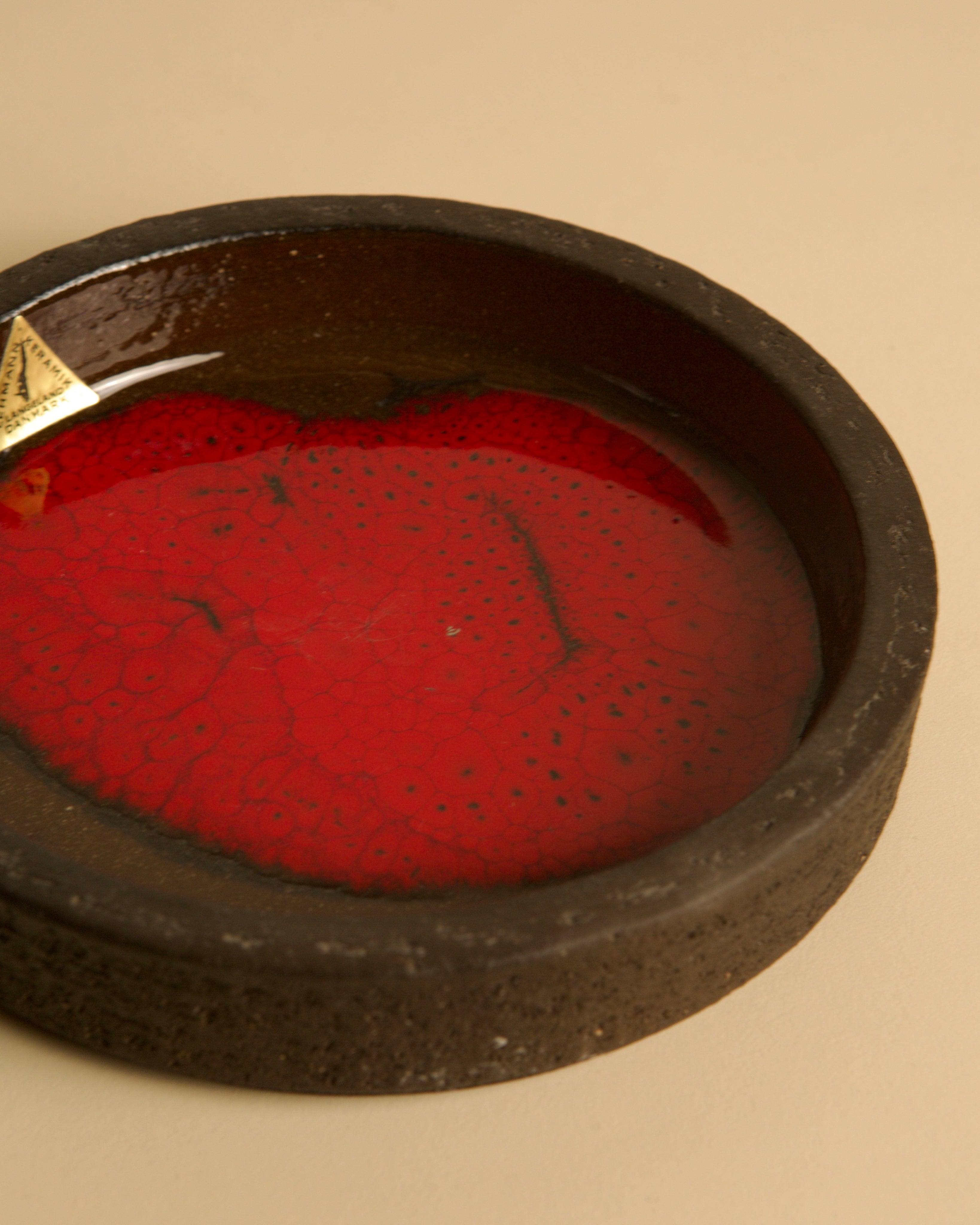 Circular Ceramic Trinket Dish by Jan Van Erp 60's — side angle showing deep red interior
