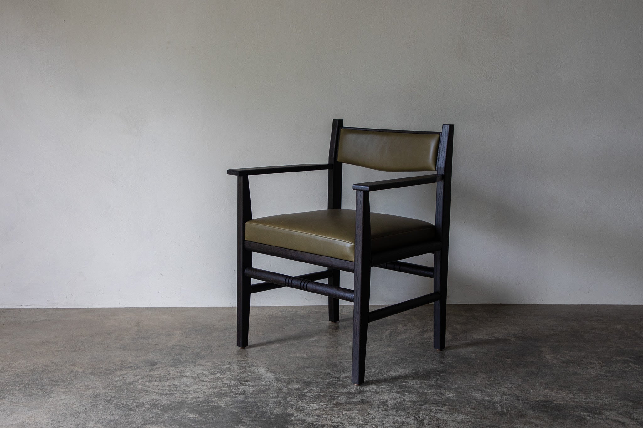Silo Upholstered Chair — angled view on concrete floor