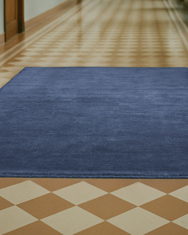 Rug 100% Wool New Zealand - Orage — side angle on checkered floor