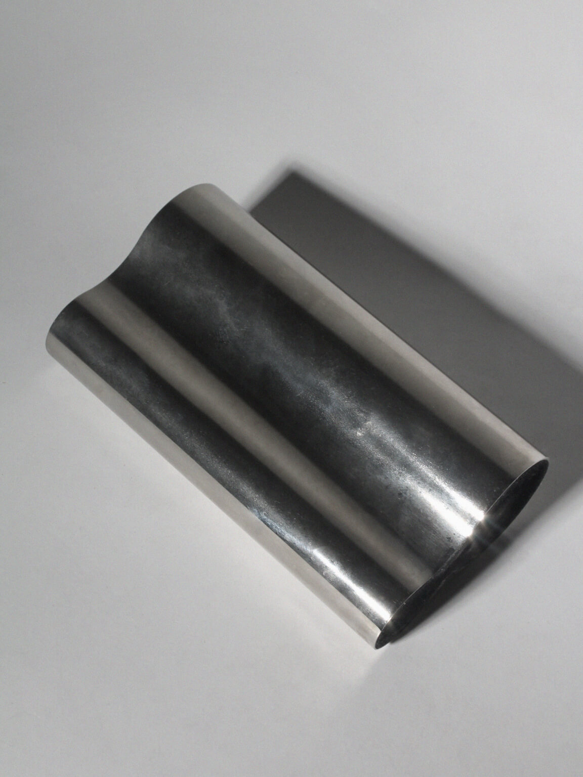 Mirrored Sculptural Stainless Steel Vase — lifestyle setting