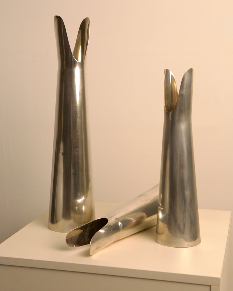 Italian silver metal Organ vases displayed on white surface detail