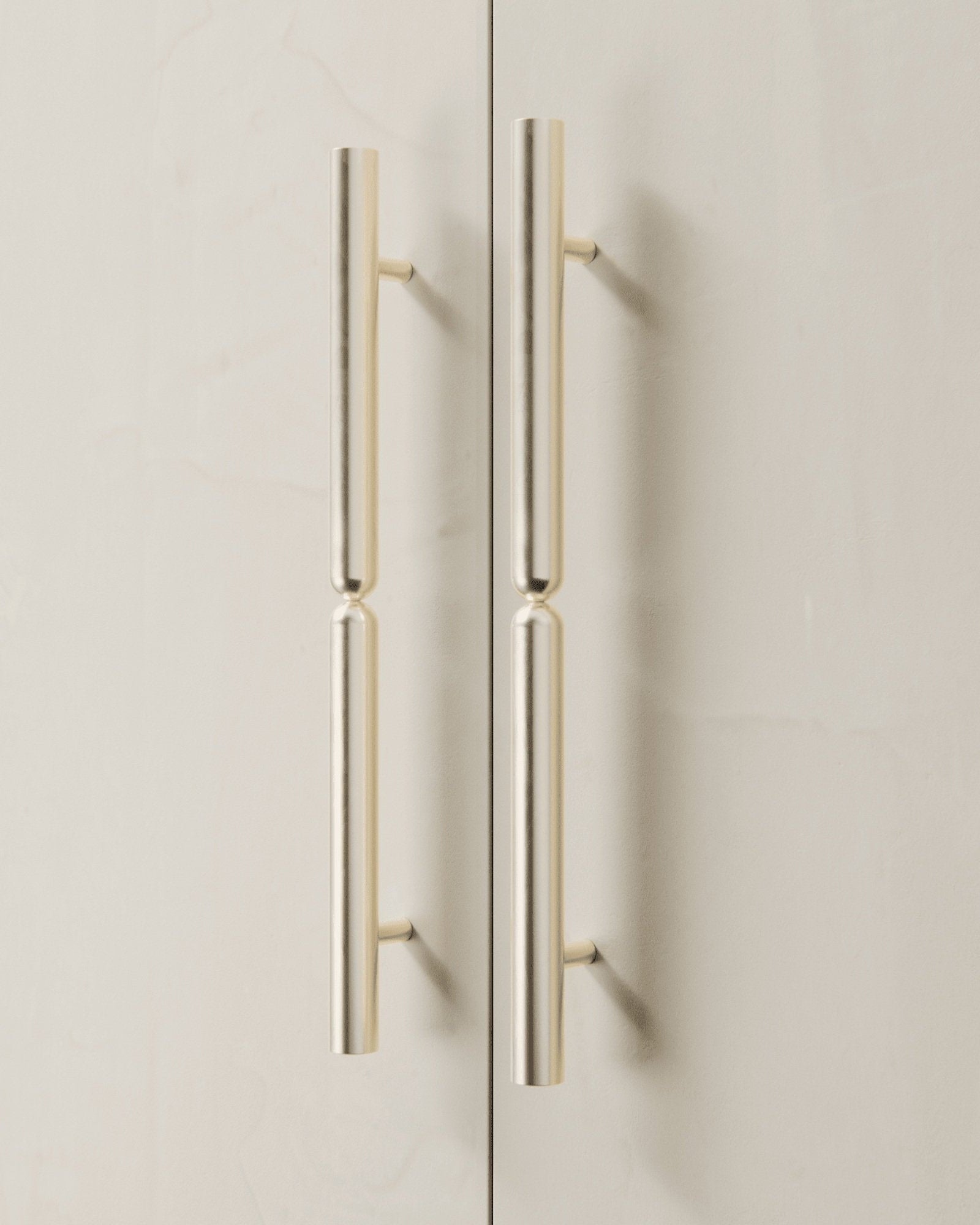 TOTEM Appliance Pull — close-up of polished metal handles on cabinet