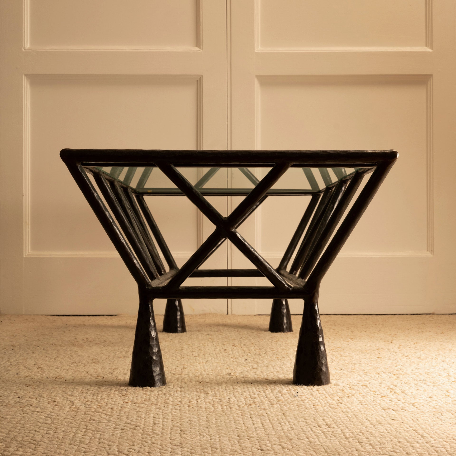 Zebra Coffee Table — angled view showing black metal frame and glass top
