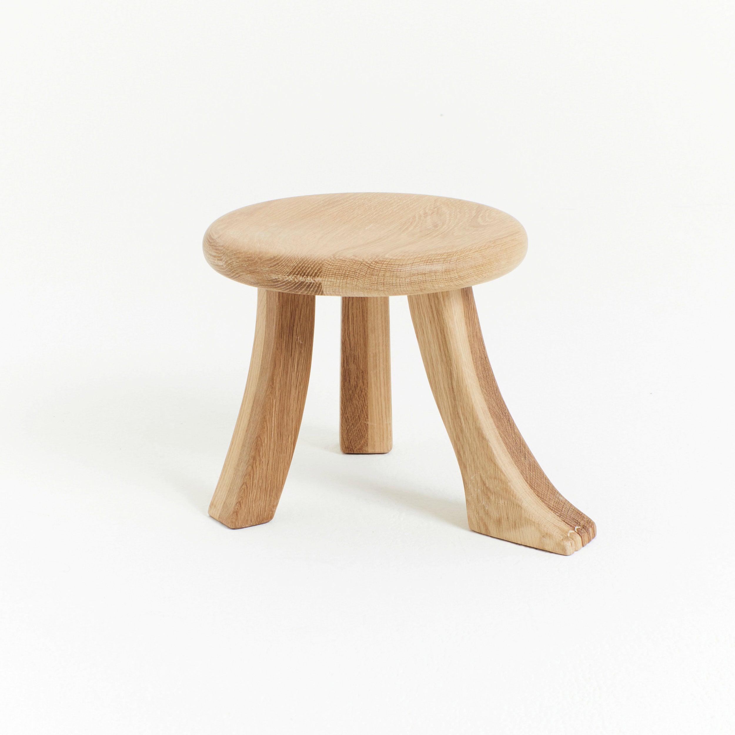 Foot Stool in Oak — close-up of round oak seat and legs