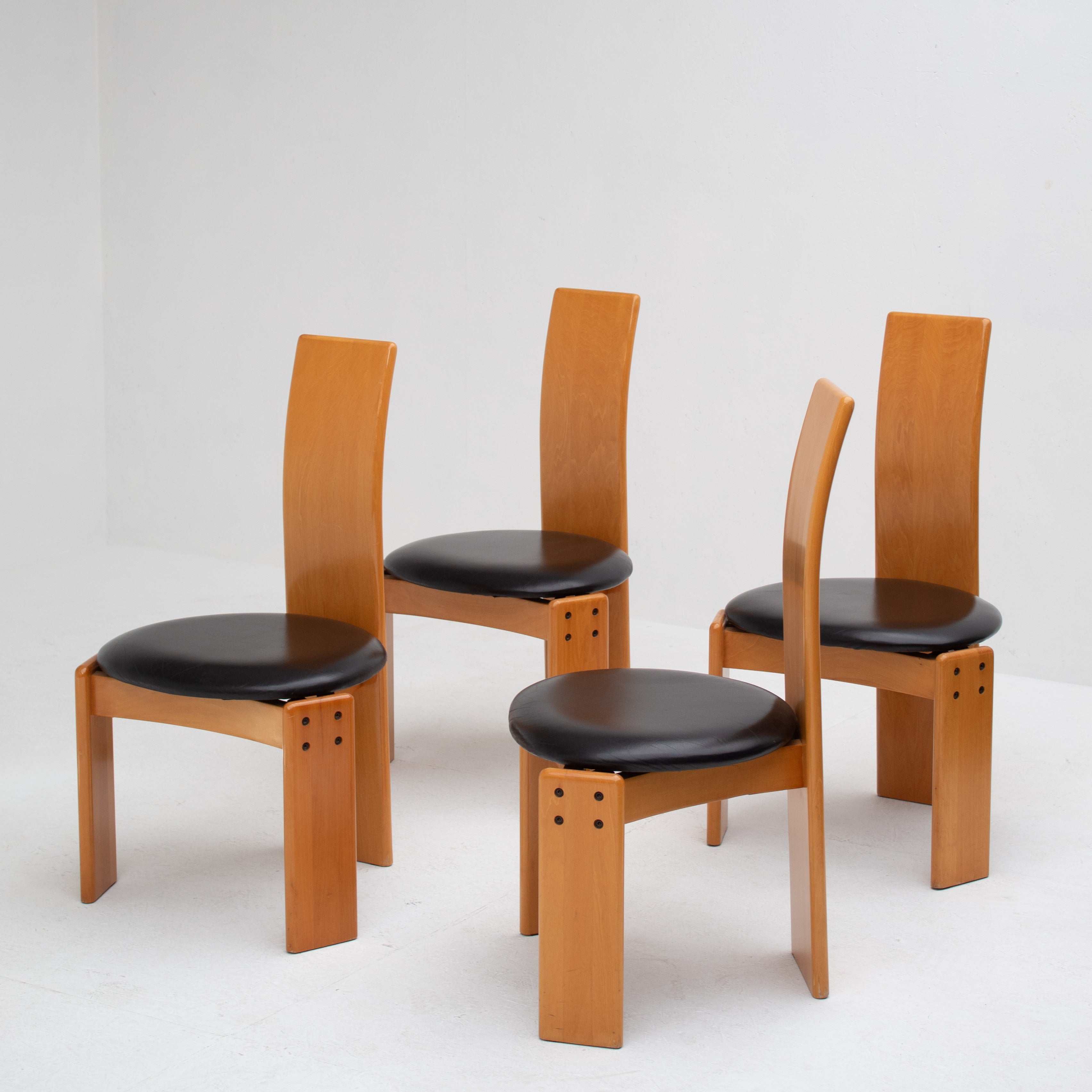 Set of Dining Chairs in Wood and Leather by Mario Marenco for Mobil Girgi — angled view showing wooden frames and black leath