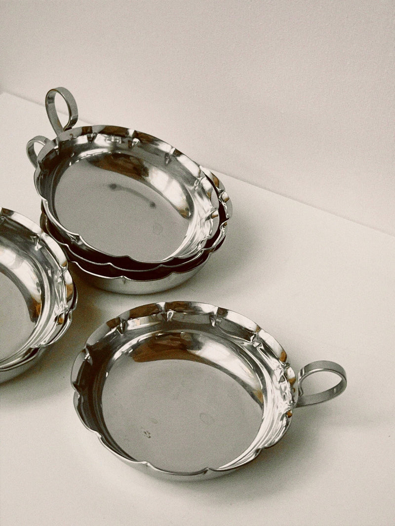 Set of three silver French tastevins with scalloped edges and handles