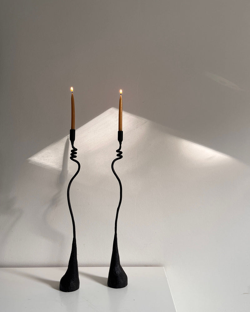 Jasmine Candleholders — close-up of black metal design with lit candles