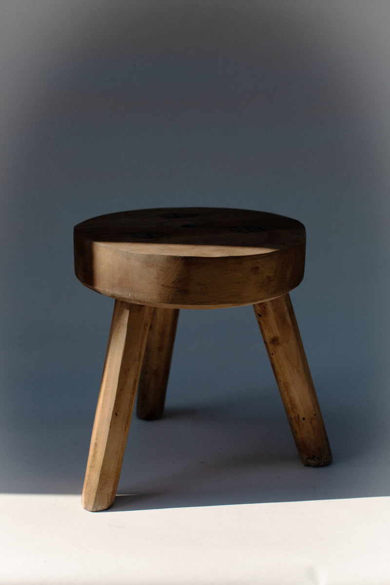 Handcrafted pine wood stool with three legs and round seat