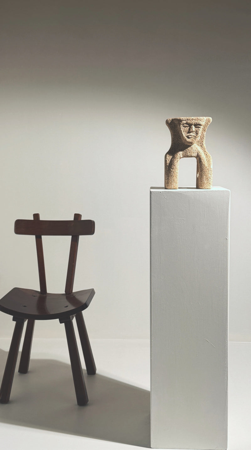 Anthropomorphic stone totem sculpture by Albert Tormos on pedestal