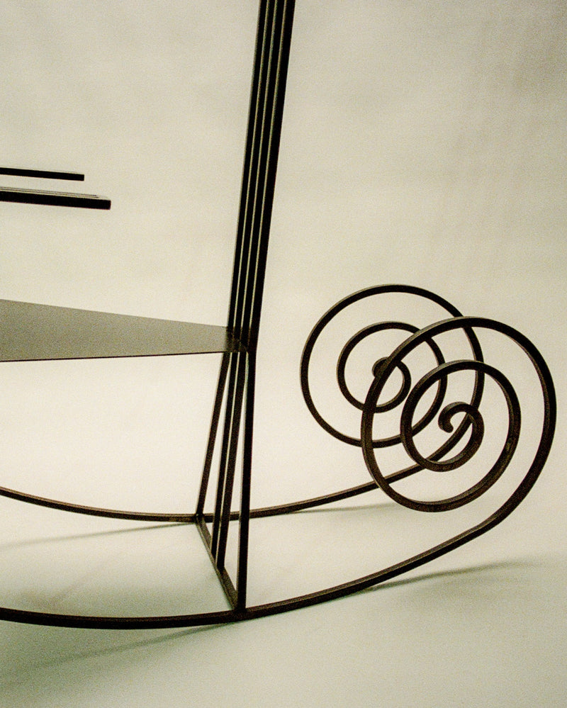 Wire frame rocking chair with spiral armrest detail