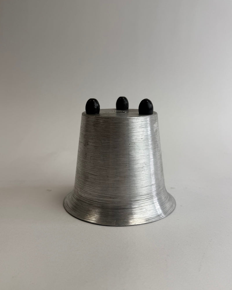 Spun Aluminum Cup by Wira NY — close-up of brushed aluminum with black feet