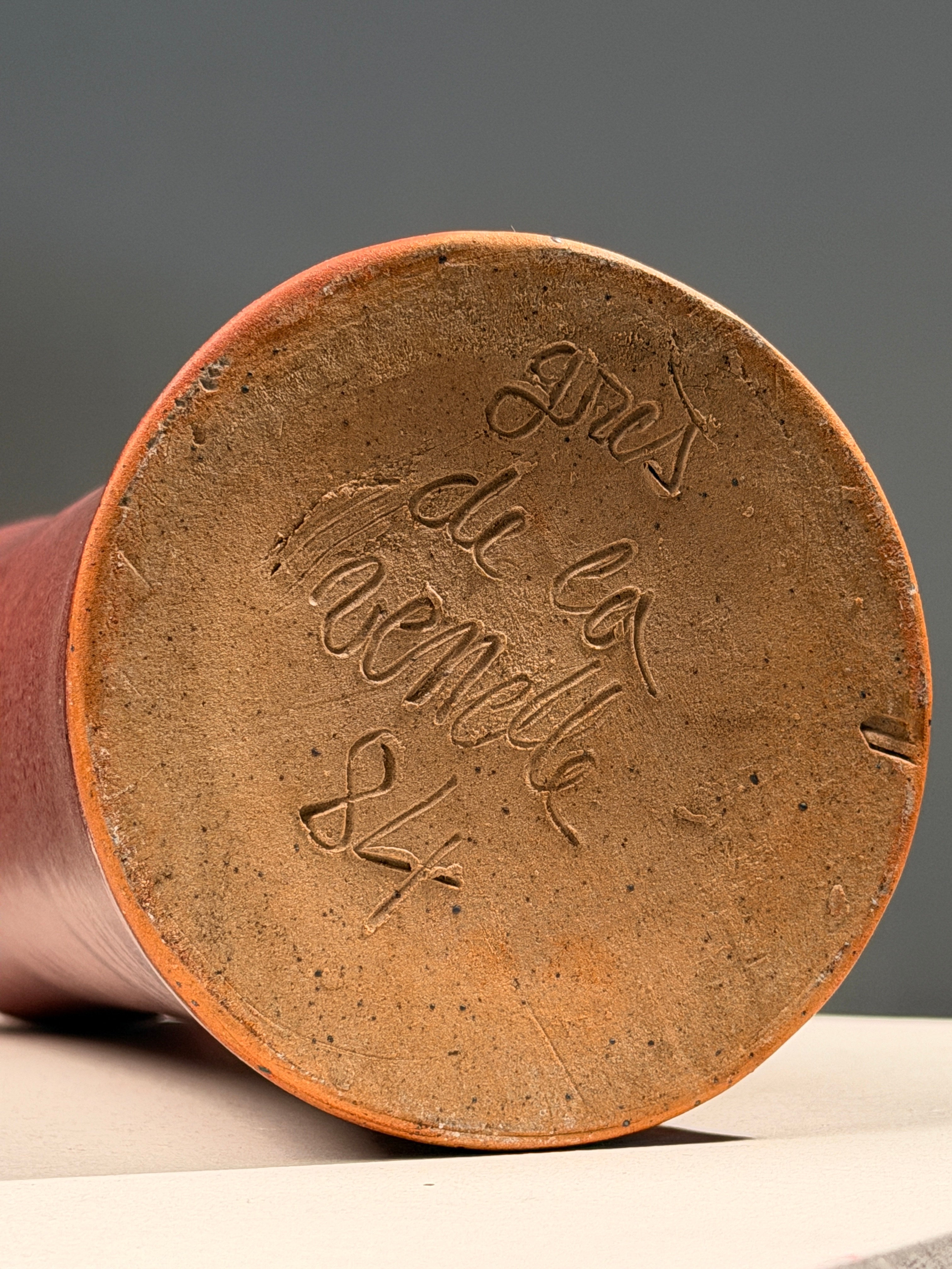 Large red stoneware soliflore bottle by Grès de la Venelle, dated 1984 — side angle