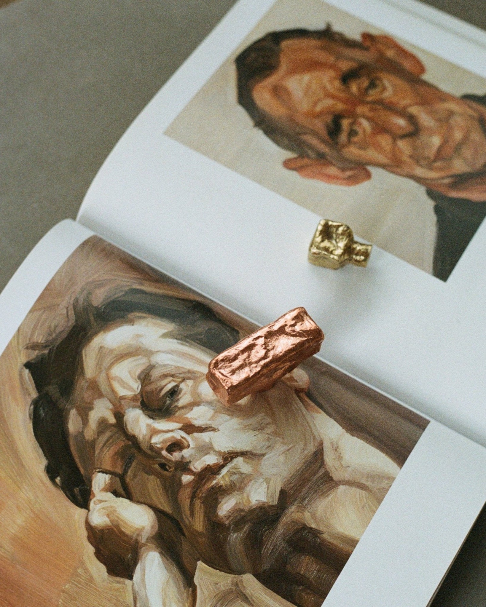 ISLE Cabinet Knob/Wall Hook Medium — top view on art book pages