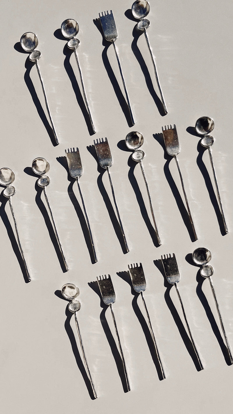 Artifact tea cutlery set aerial view showing spoons and forks
