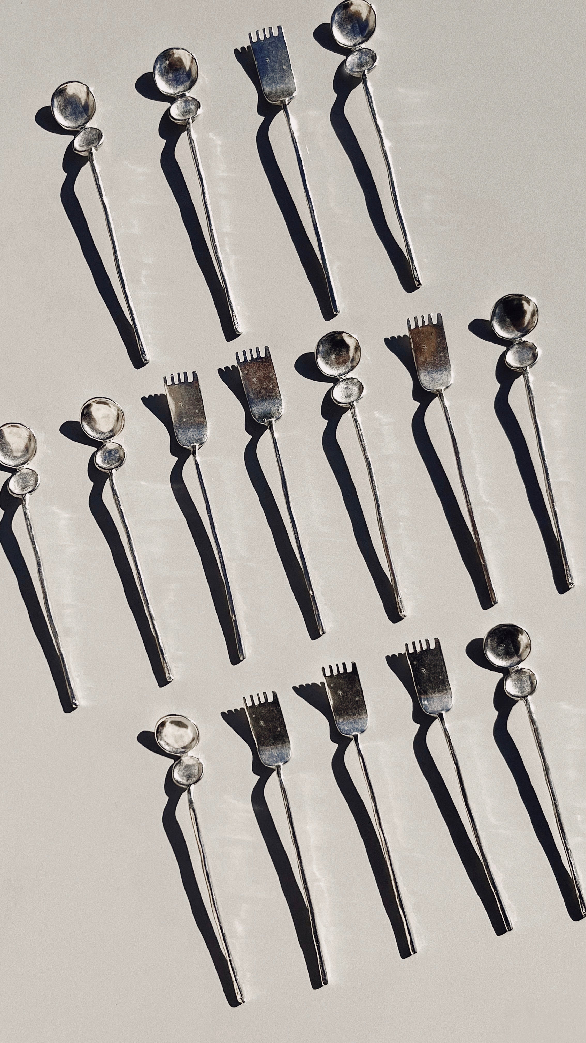 Artifact tea cutlery set aerial view showing spoons and forks
