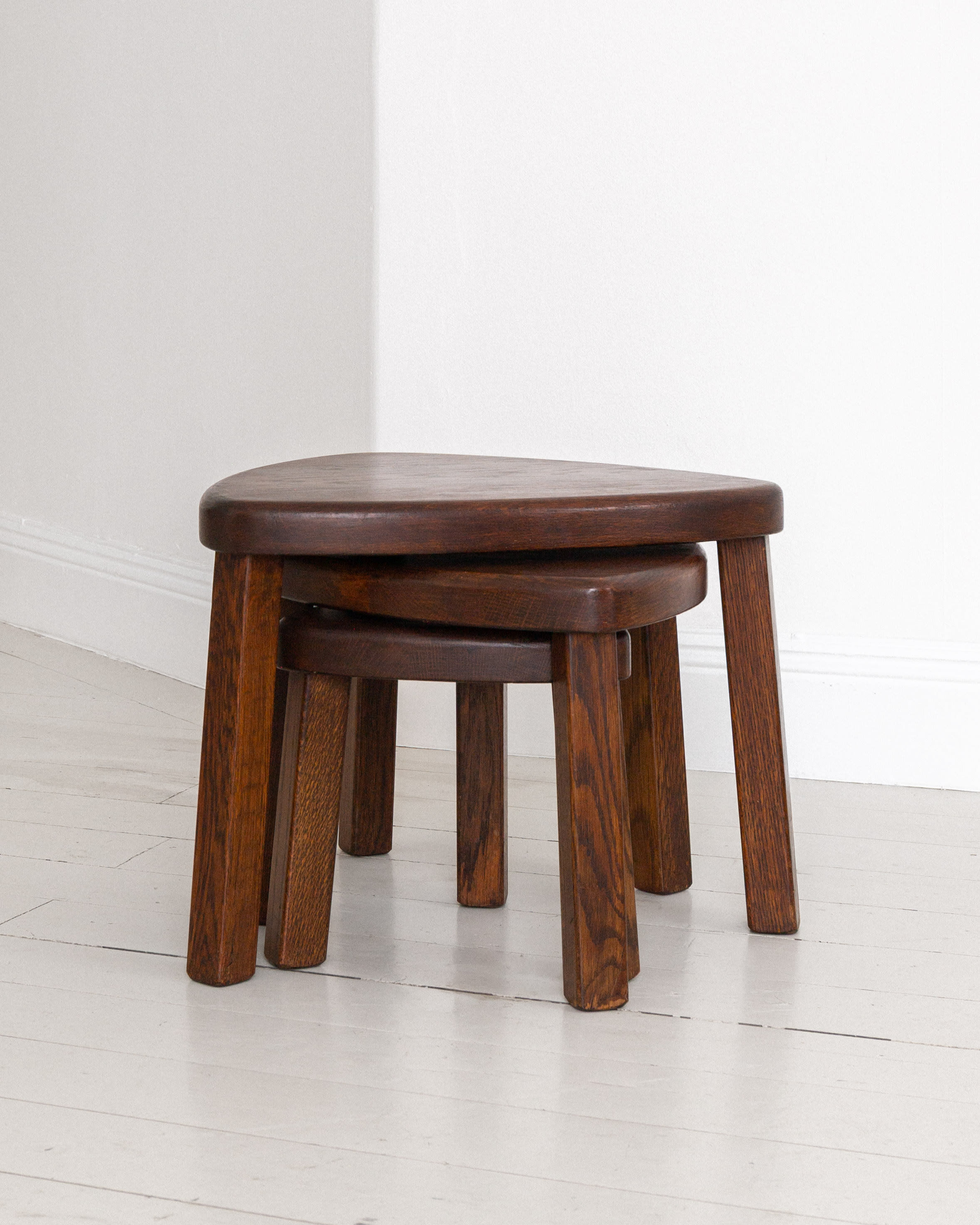 Set of Three Oak Brutalist Nesting Tables, Netherlands, 1970s — angled view showing dark oak finish in minimalist setting