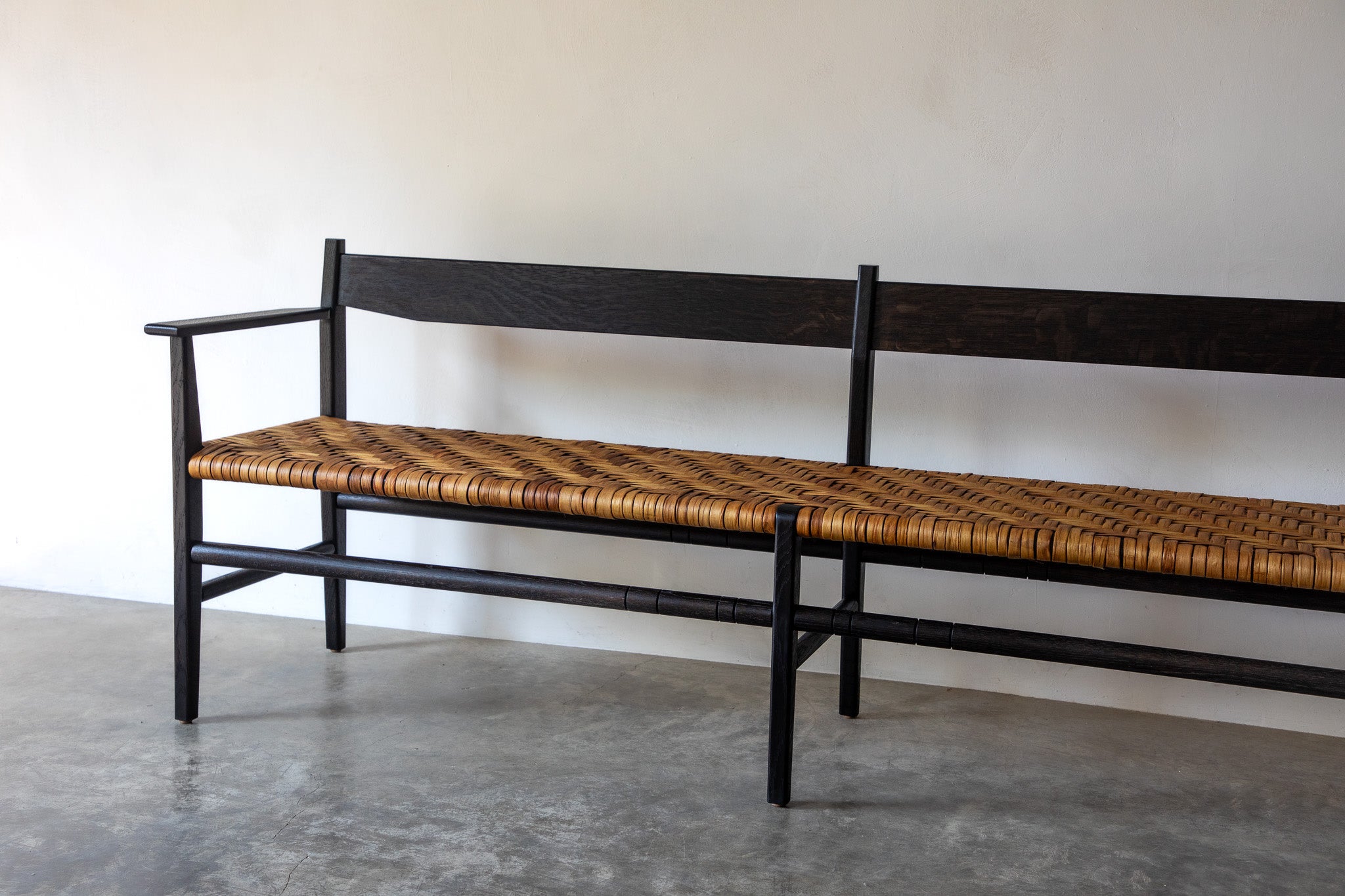 Silo Bench — close-up of woven seat and dark wood frame