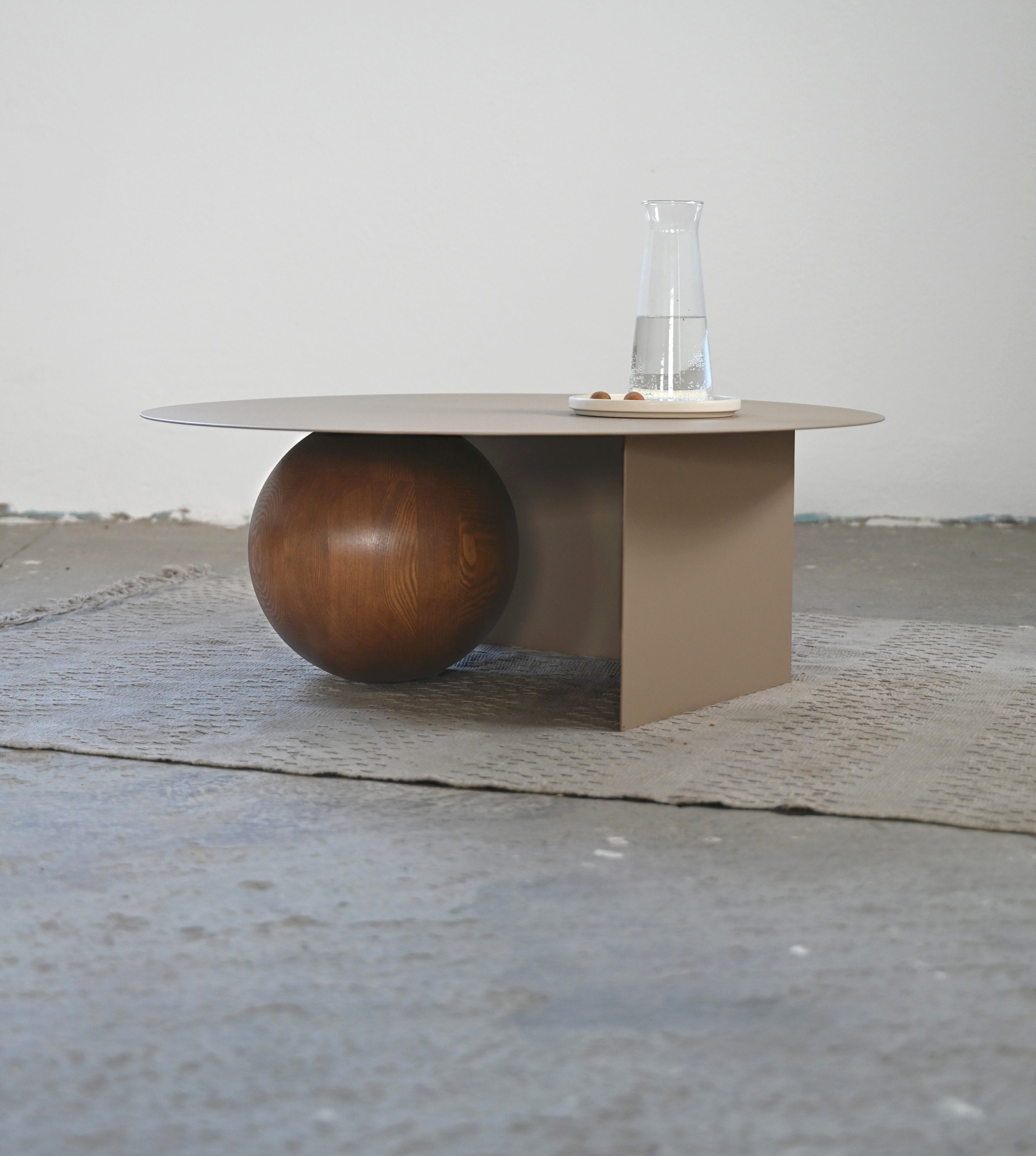 FUKU Coffee Table — angled view with wooden sphere base in minimalist setting