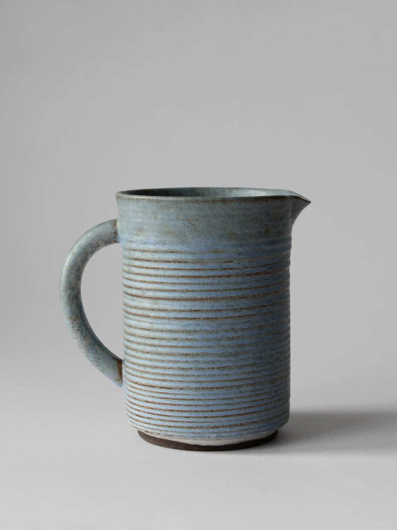 Turquoise ribbed ceramic pitcher with handle and spout