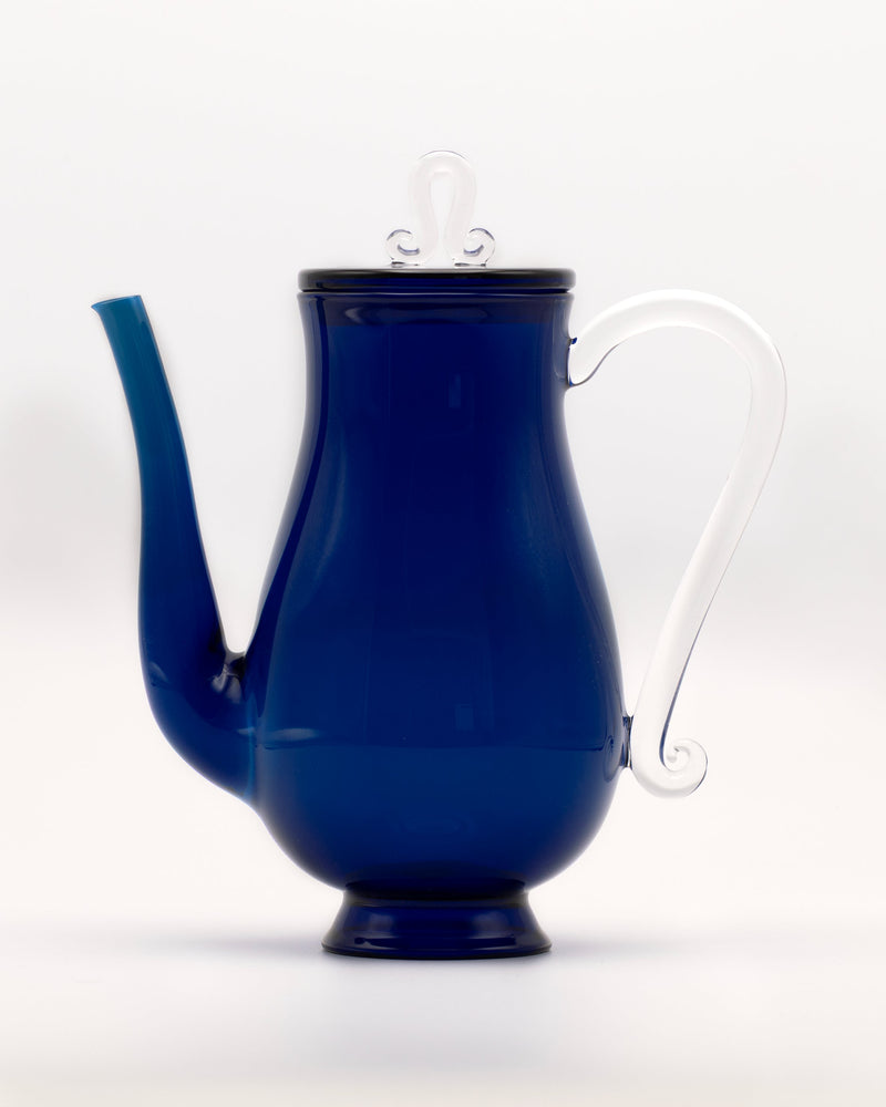 Bell Pot — side view of blue glass teapot with white handle
