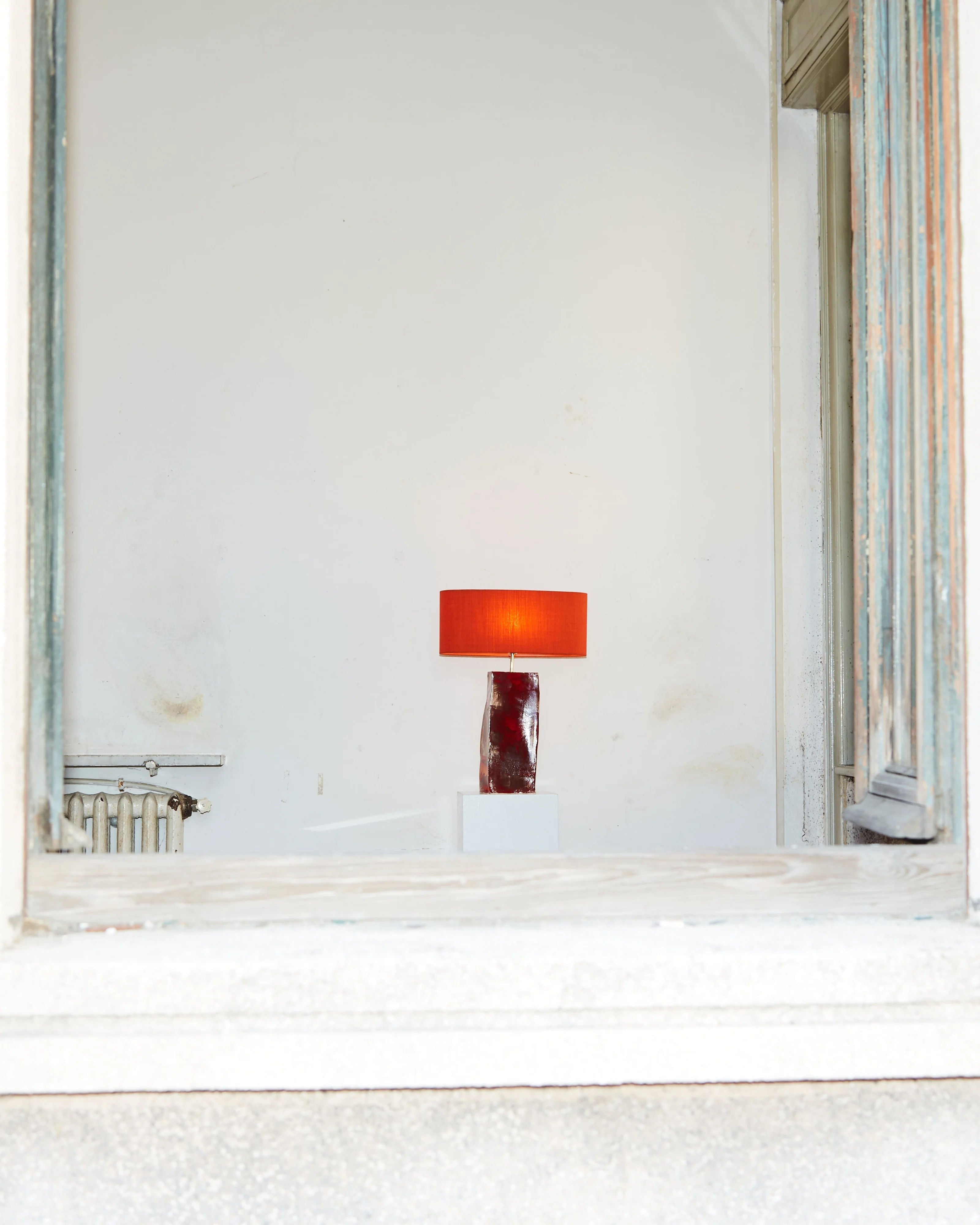 Rectangular Ceramic Lamp — side view with orange shade in minimalist setting