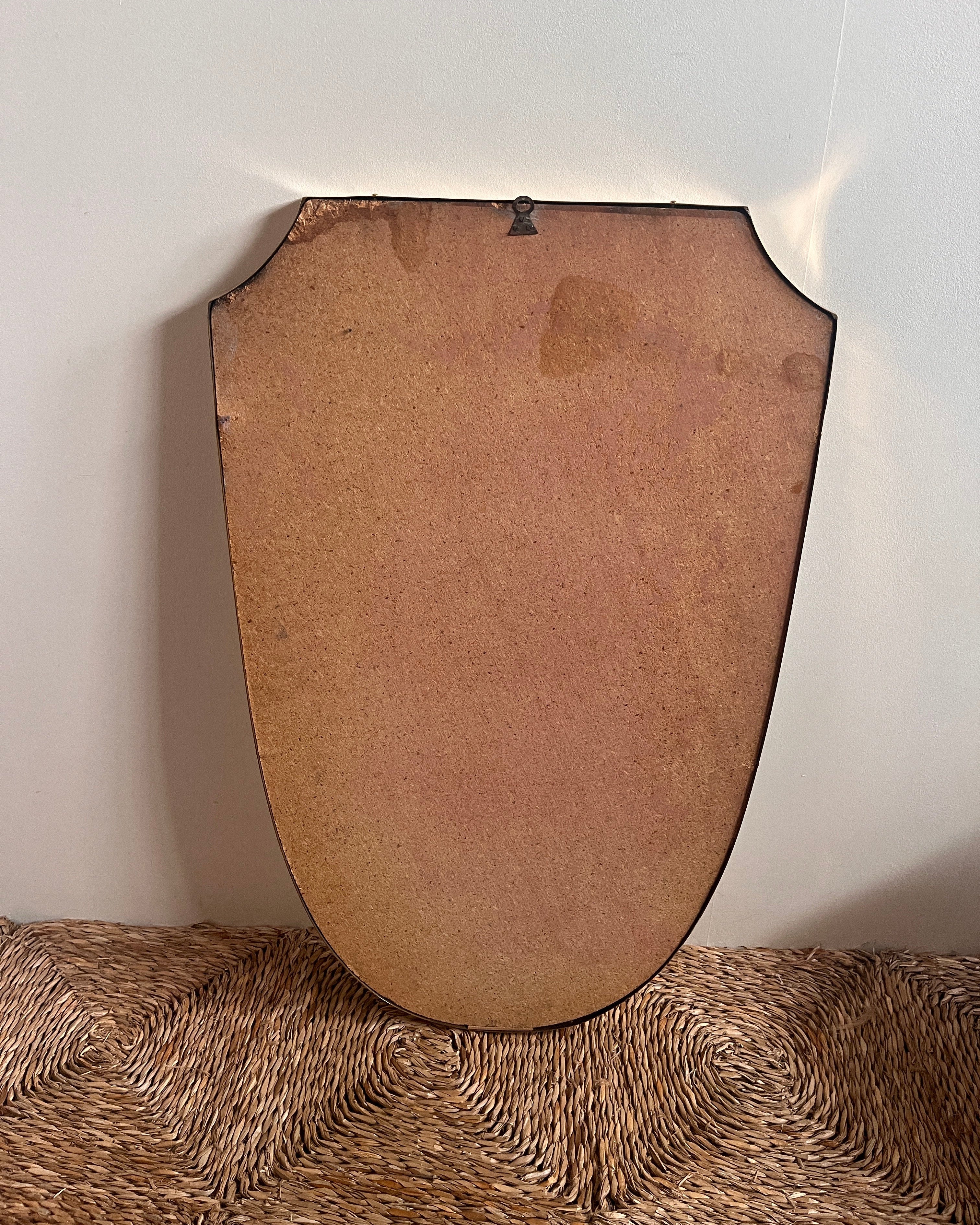 Back view of mid-century Italian brass shield mirror frame