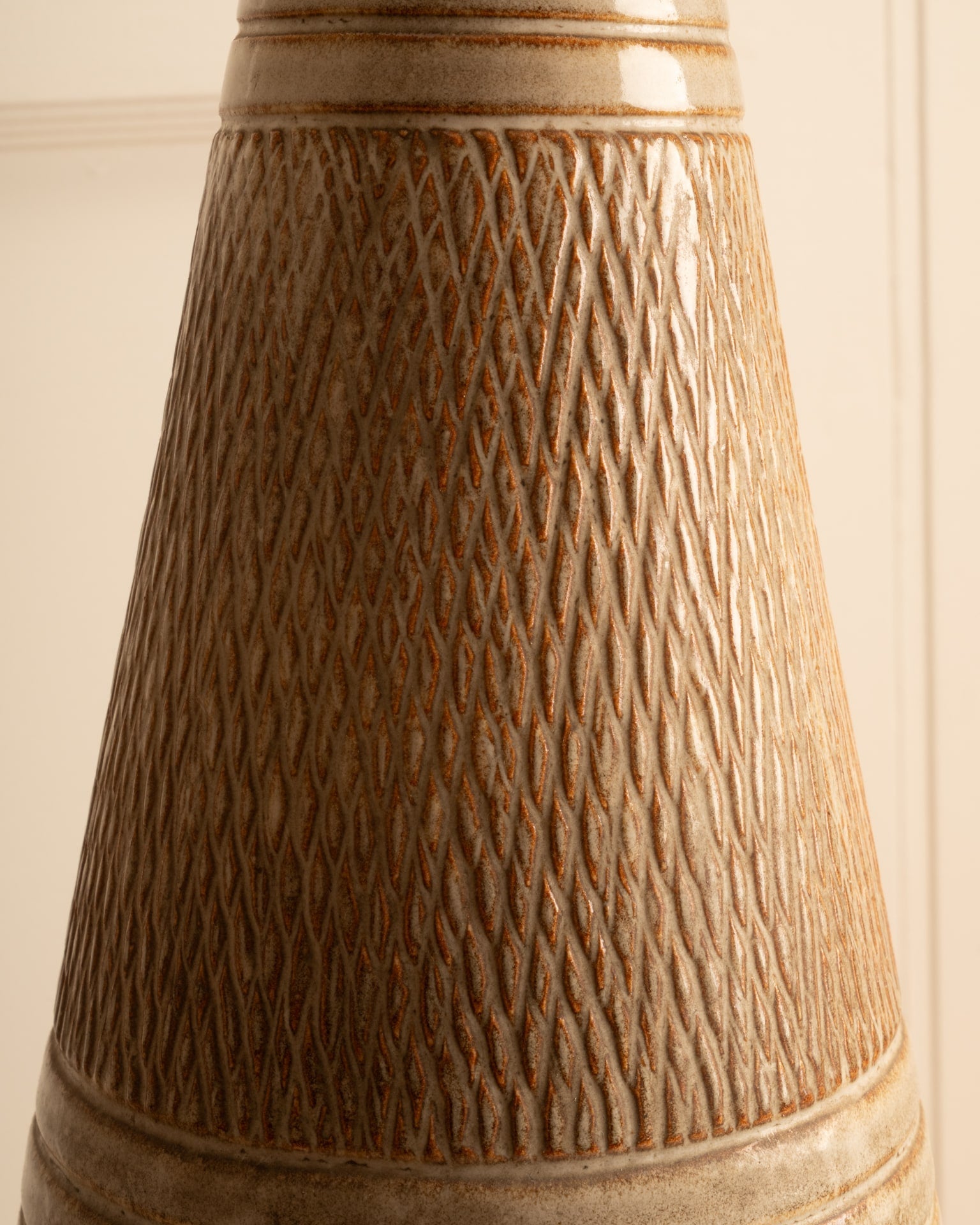 Textured ceramic surface detail of Danish table lamp base