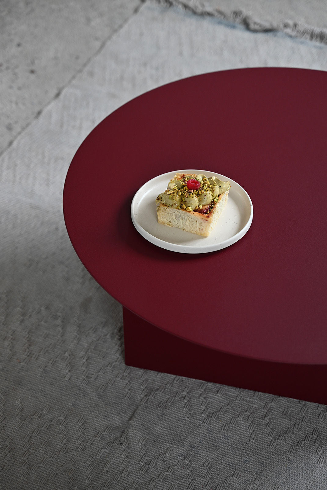 FUKU Coffee Table — top view with deep red surface and snack plate