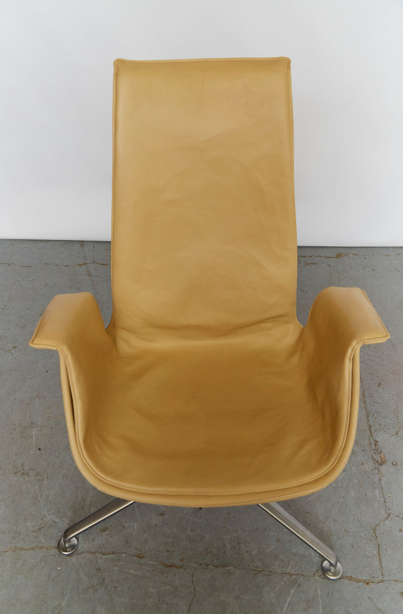 Mustard leather Tulip swivel chair front view on concrete floor