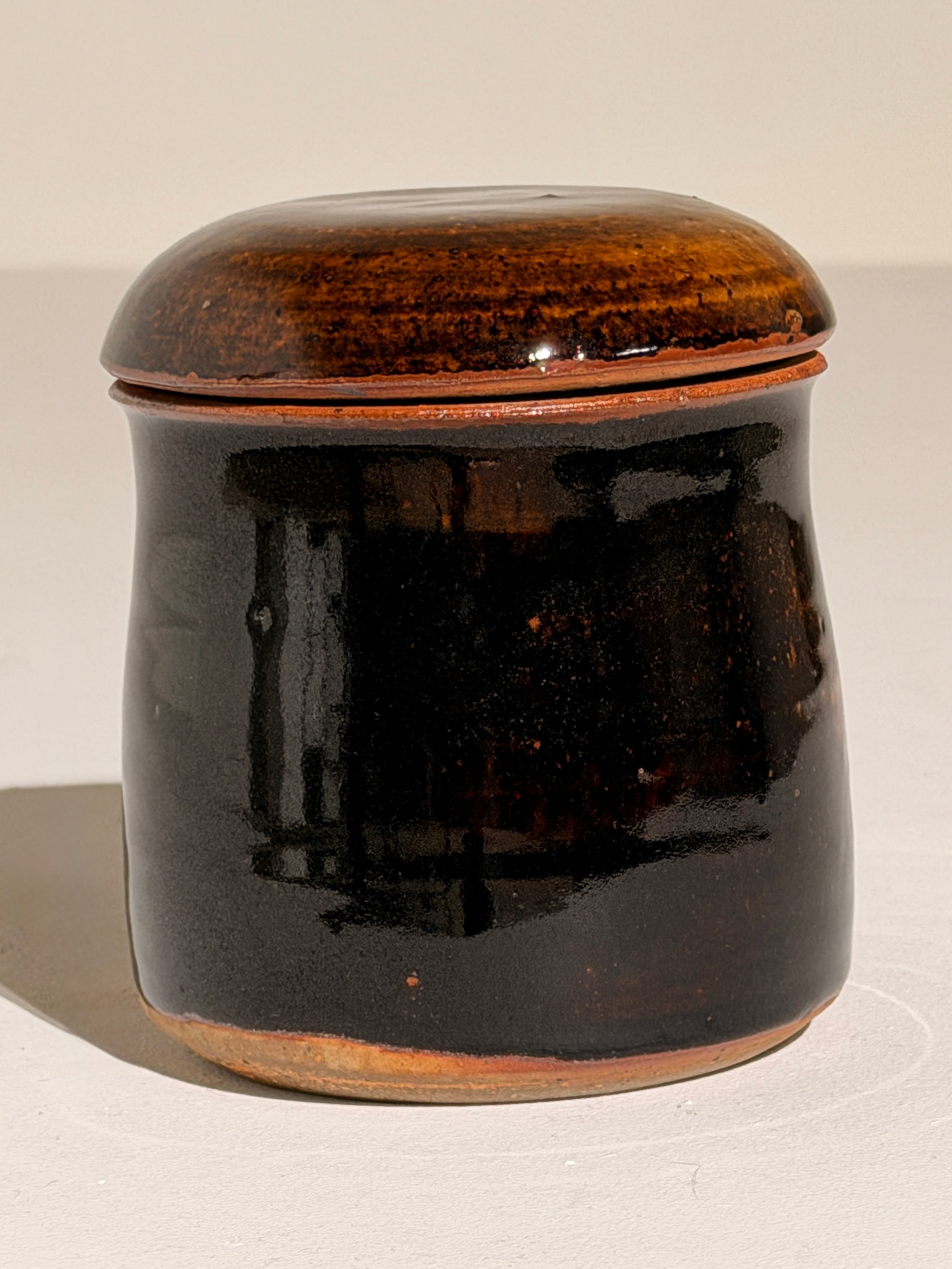 Lidded Stoneware Pot, France, circa 1960–1970 — side angle showing glossy black glaze