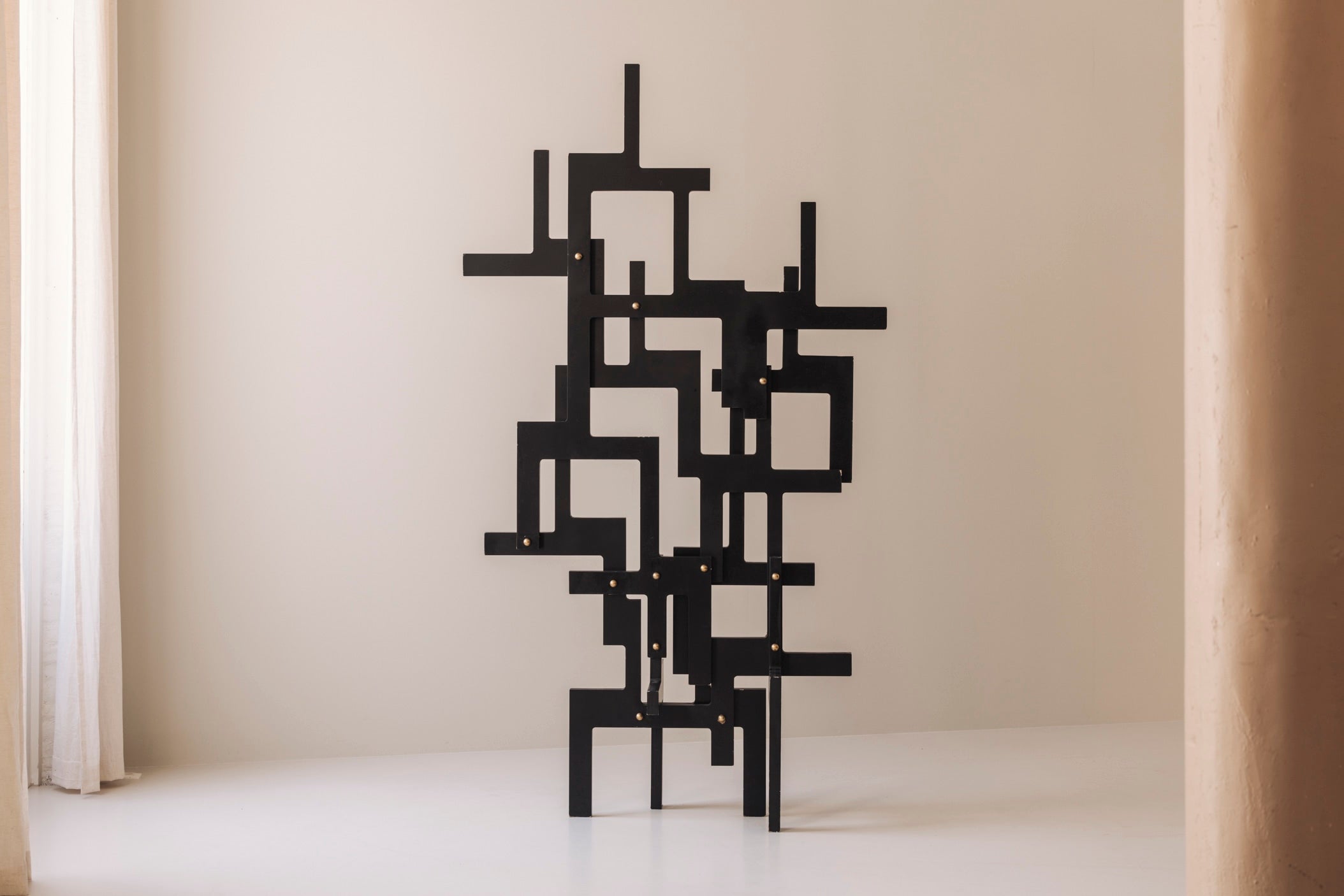 Large geometric abstract sculpture in lacquered wood and brass, France 1990s — side angle