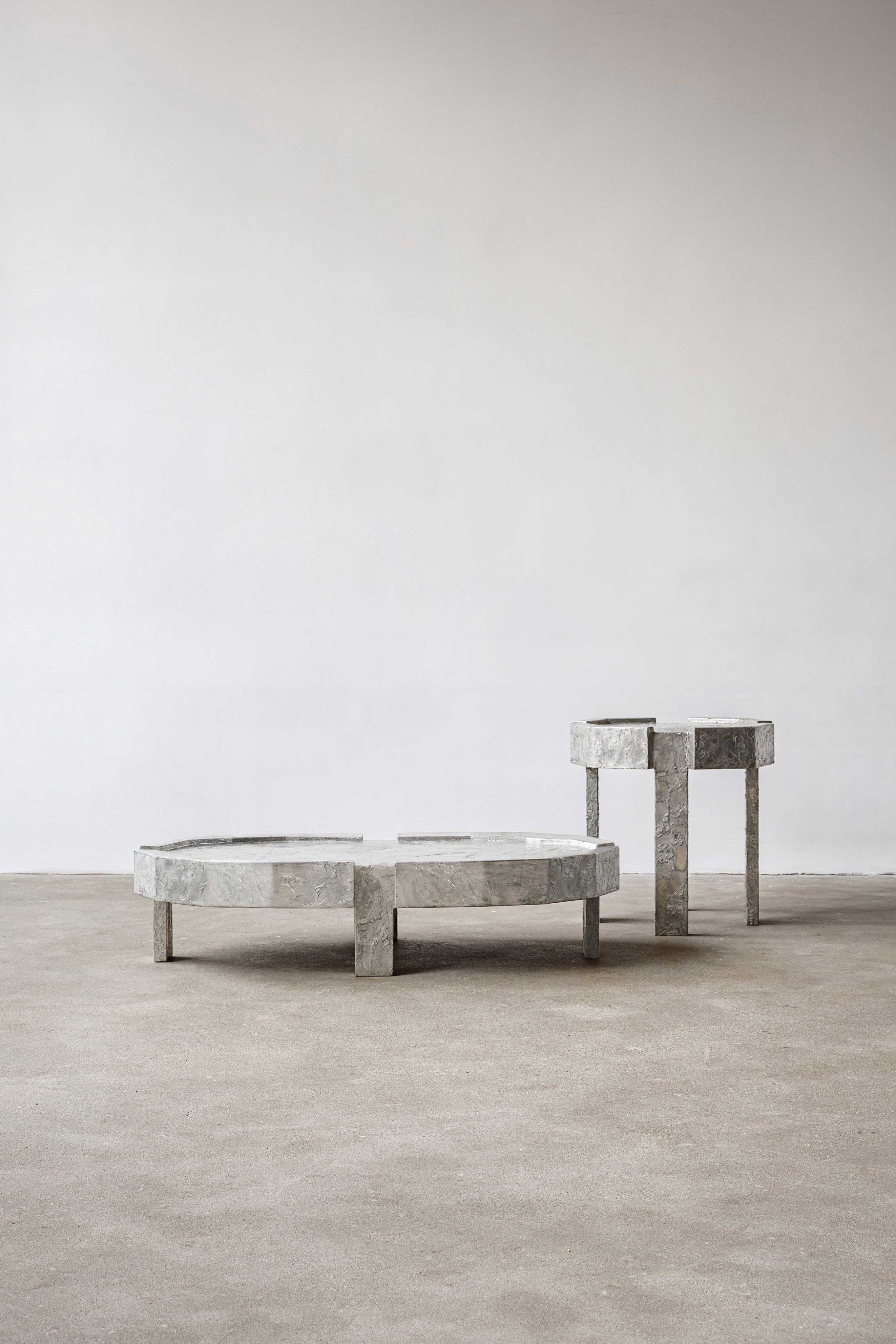 Splav Tin Table (smaller) — side angle showing gray tin material on concrete floor