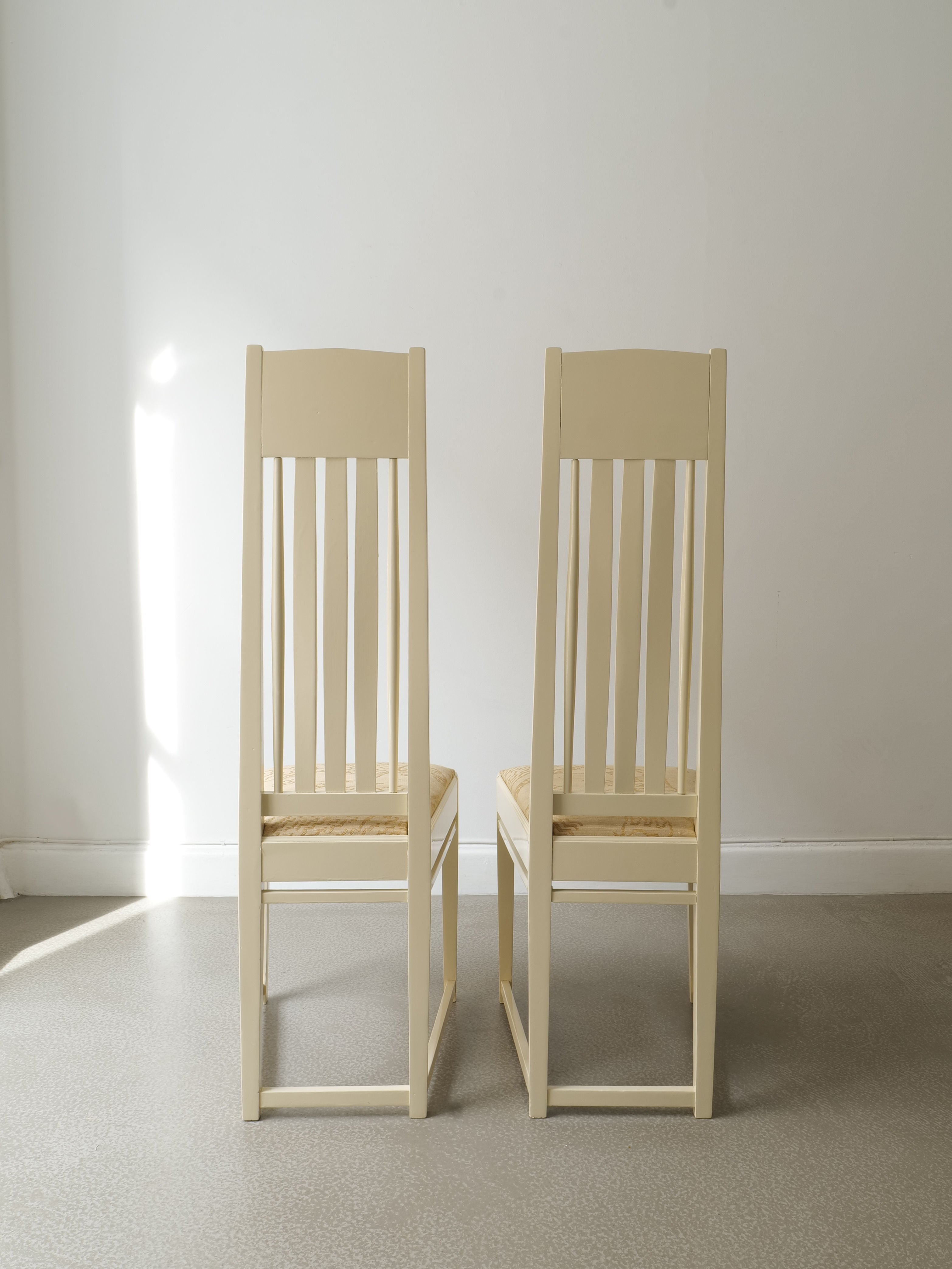 Two light wood Swedish Jugend accent chairs with vertical slat backs