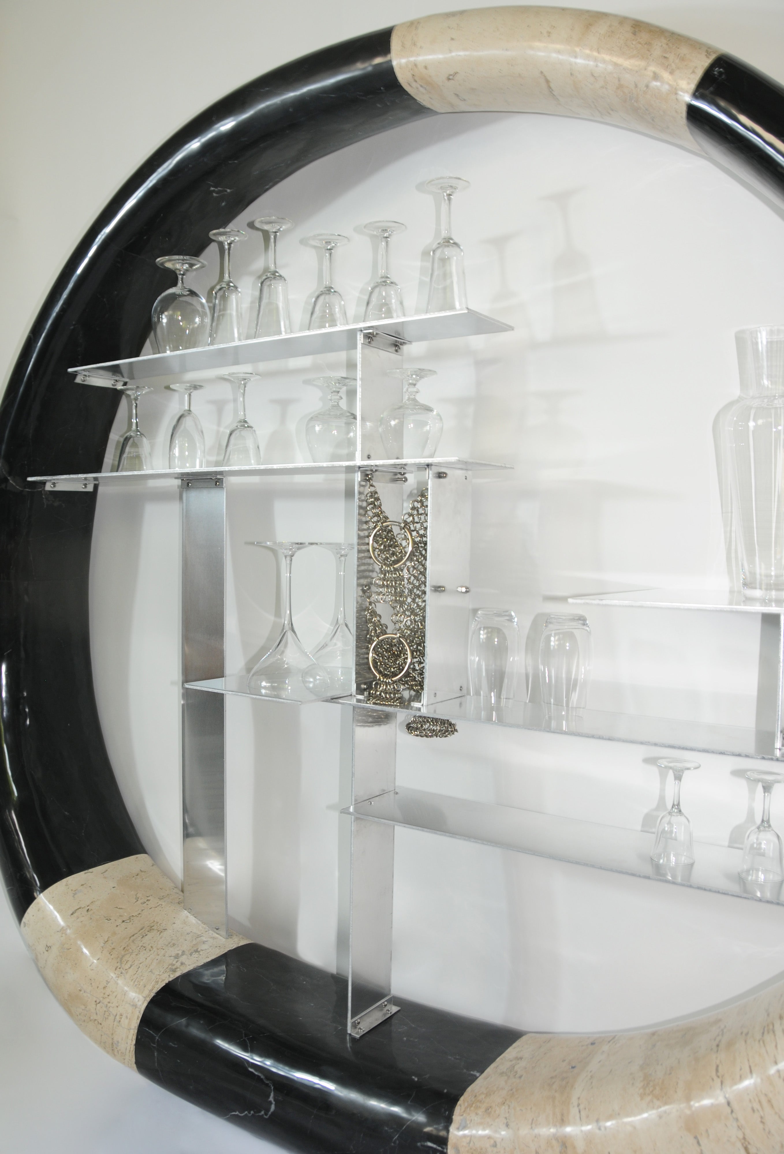 Asymmetric Stone Ring Shelf, Postmodern — close-up of glassware on clear shelves