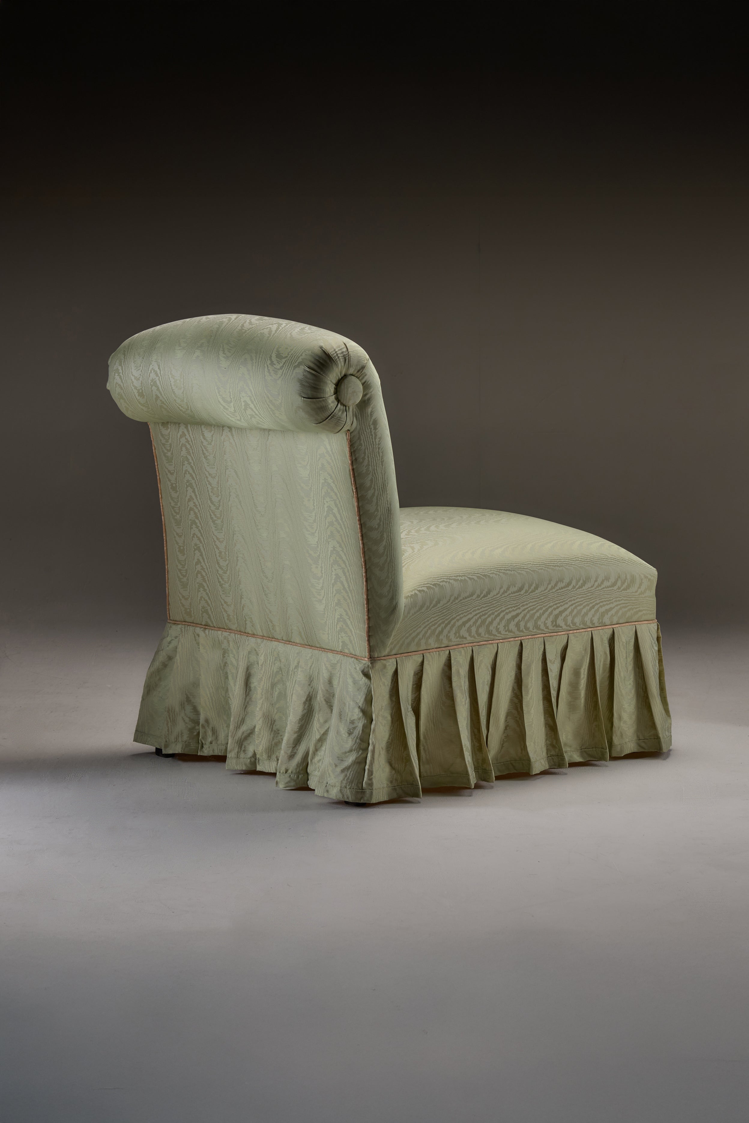 HESTIA SLIPPER CHAIR — back view with light green upholstery and pleated skirt