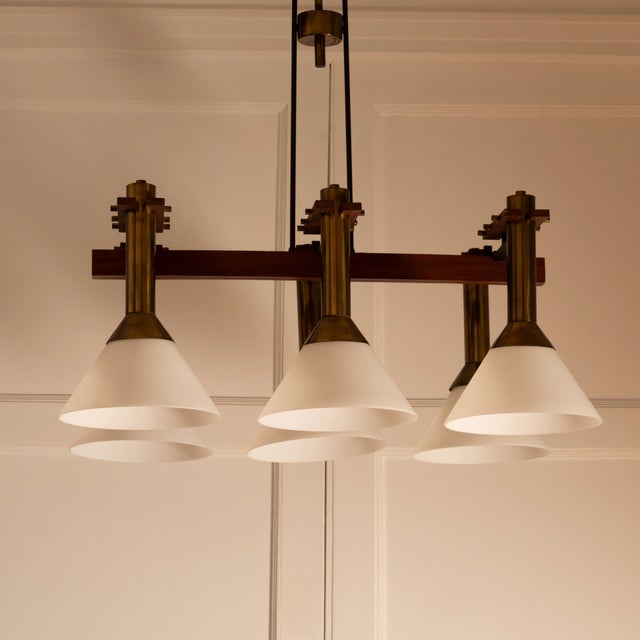 Six-light pendant lamp — close-up of brass and frosted glass shades