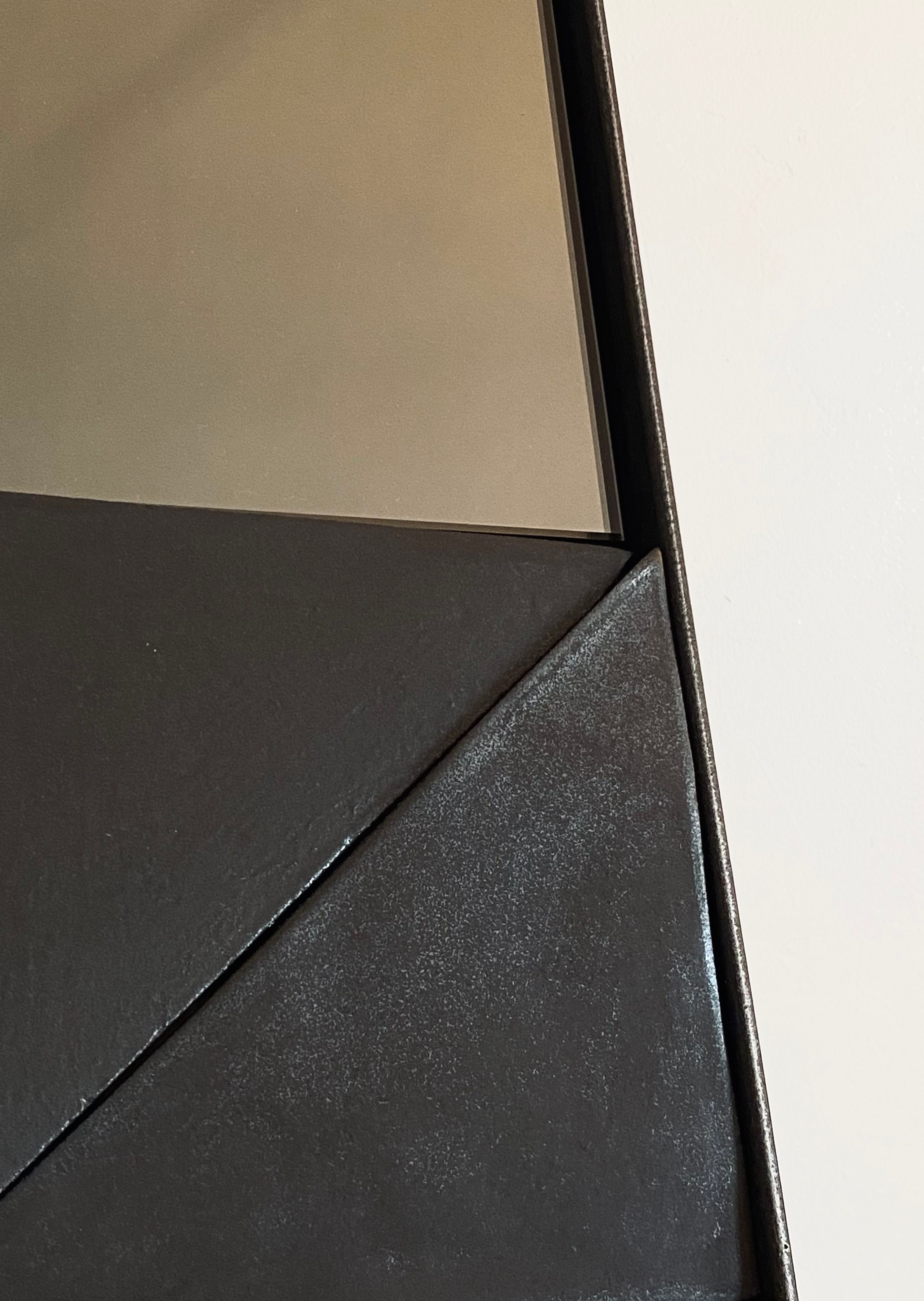 Alcoa mirror corner detail showing bronze frame and dark surface