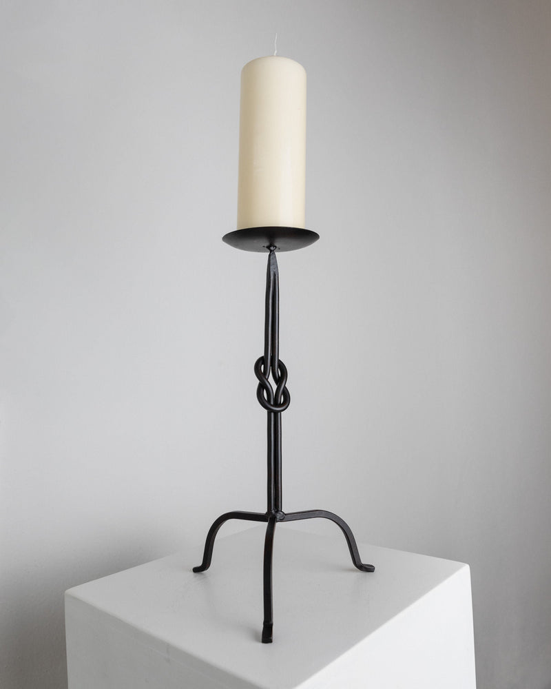 Candleholder Hand-forged Iron - Italy 1970s — close-up of black iron base with candle
